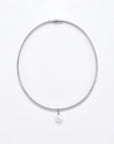 A minimalist For Art's Sake® Orbit Necklace Silver with a single, round freshwater pearl pendant. The necklace is closed with a sleek metal clasp and is displayed against a plain white background.