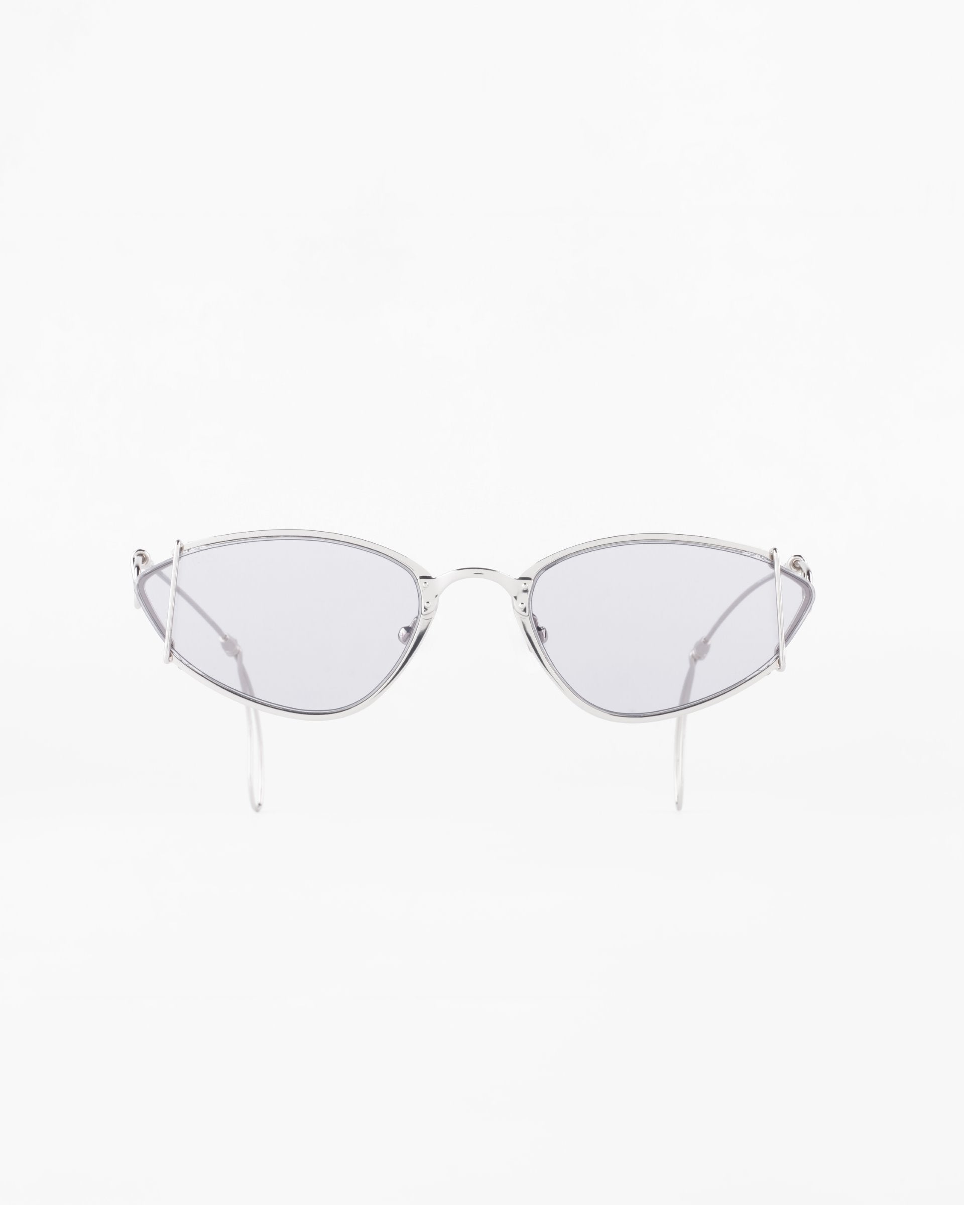 A pair of stylish sunglasses with thin, gold-plated stainless steel frames and slightly tinted, elongated oval lenses against a white background. The glasses have a modern and minimalist design with delicate temples that offer 100% UVA &amp; UVB protection. These are the Ornate by For Art&#39;s Sake®.