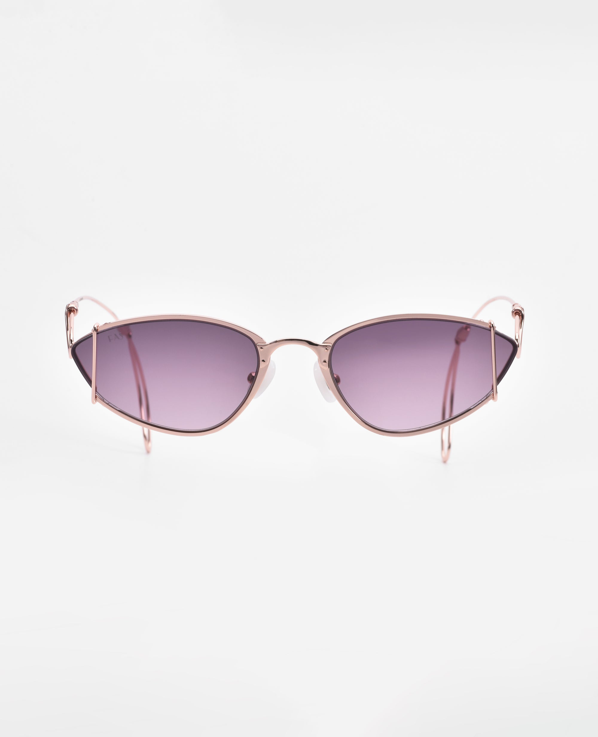 A pair of stylish, cat-eye sunglasses with rose gold-plated stainless steel frames and dark purple lenses. The Ornate by For Art's Sake® are centered against a white background, showcasing their sleek and modern design while offering 100% UVA & UVB protection and an anti-reflective coating.