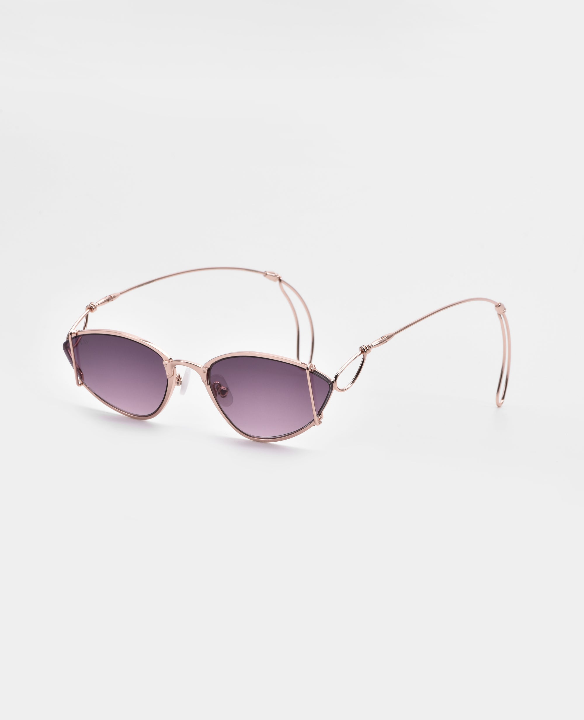 Ornate sunglasses from For Art&#39;s Sake® with 18-karat gold-plated rose gold frames and purple-tinted, ultra-lightweight nylon lenses. The design features a unique, minimalist wire temple and nose bridge, adding a modern and stylish touch. Offers 100% UVA &amp; UVB protection against harmful rays.