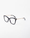 A pair of For Art's Sake® Paris Two black framed glasses with gold accents and chain-like details on the temples are positioned against a plain white background. The lenses, featuring a blue light filter, are clear, and the overall design is modern and stylish.