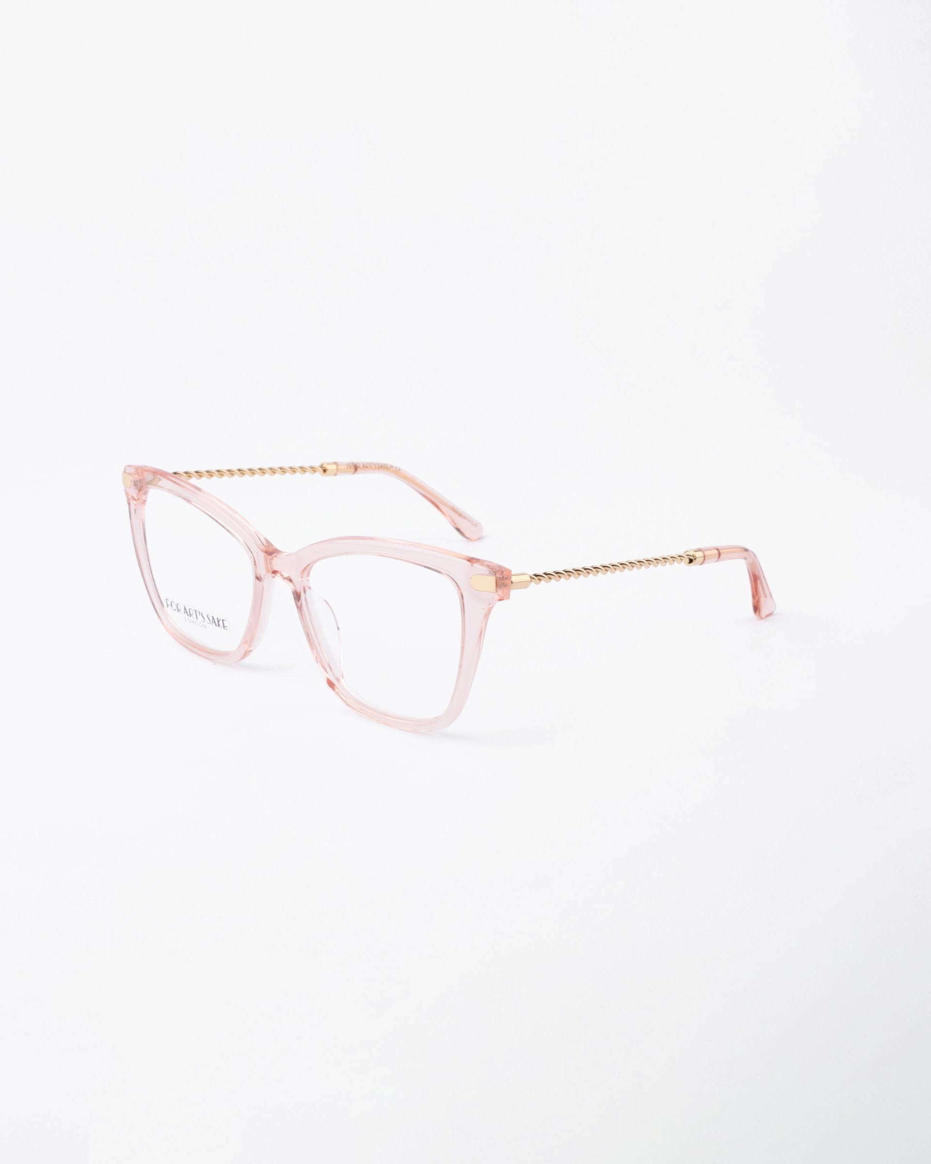 A pair of stylish eyeglasses with clear pink square frames and gold temple arms, featuring a textured design. With UV protection and a blue light filter, the Paris Two by For Art&#39;s Sake® are perfect for both fashion and function. The glasses are displayed on a white background.