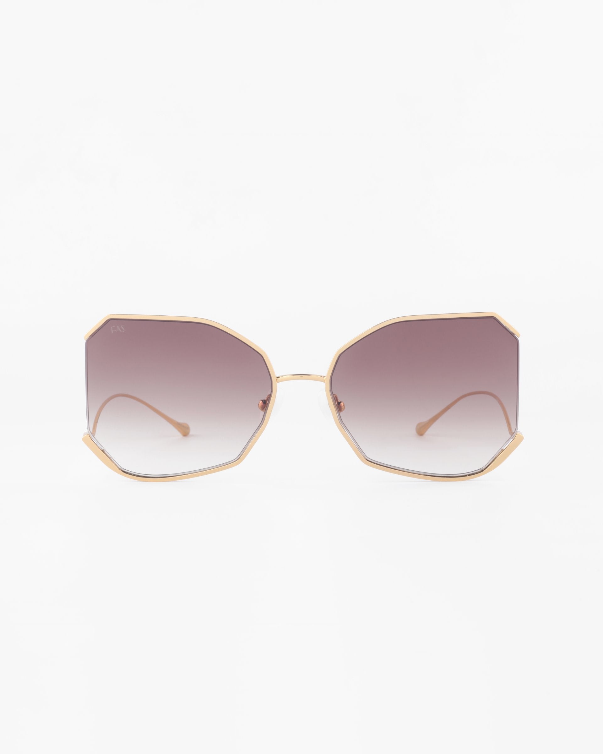 Front view of a pair of For Art's Sake® Painter sunglasses with gradient lenses and a geometric, angular frame in gold-plated stainless steel. The ultra-lightweight Nylon lenses transition from a dark tint at the top to a lighter tint at the bottom, offering 100% UVA & UVB protection. The temple arms are thin with matching gold accents.