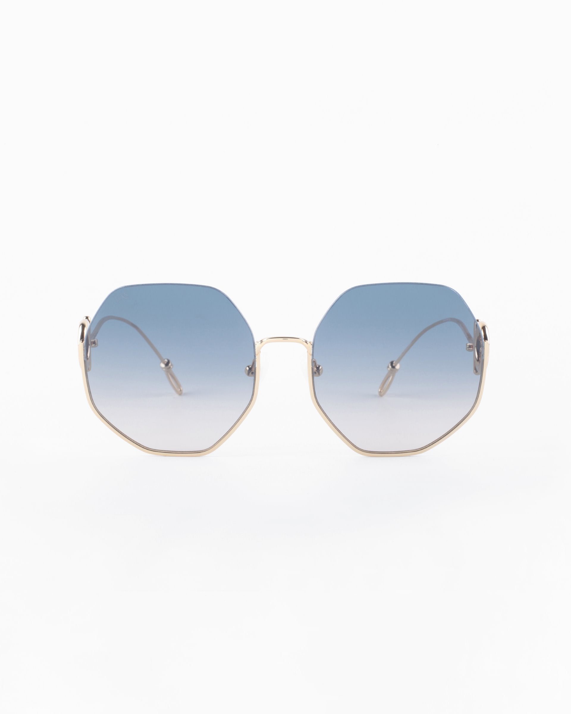 Front view of Palace sunglasses by For Art&#39;s Sake® with gradient blue lenses and thin 18-karat gold-plated frames. The arms of the sunglasses are also gold, with white earpieces. These UVA &amp; UVB-protected sunglasses are Limited Edition. The image has a clean white background.