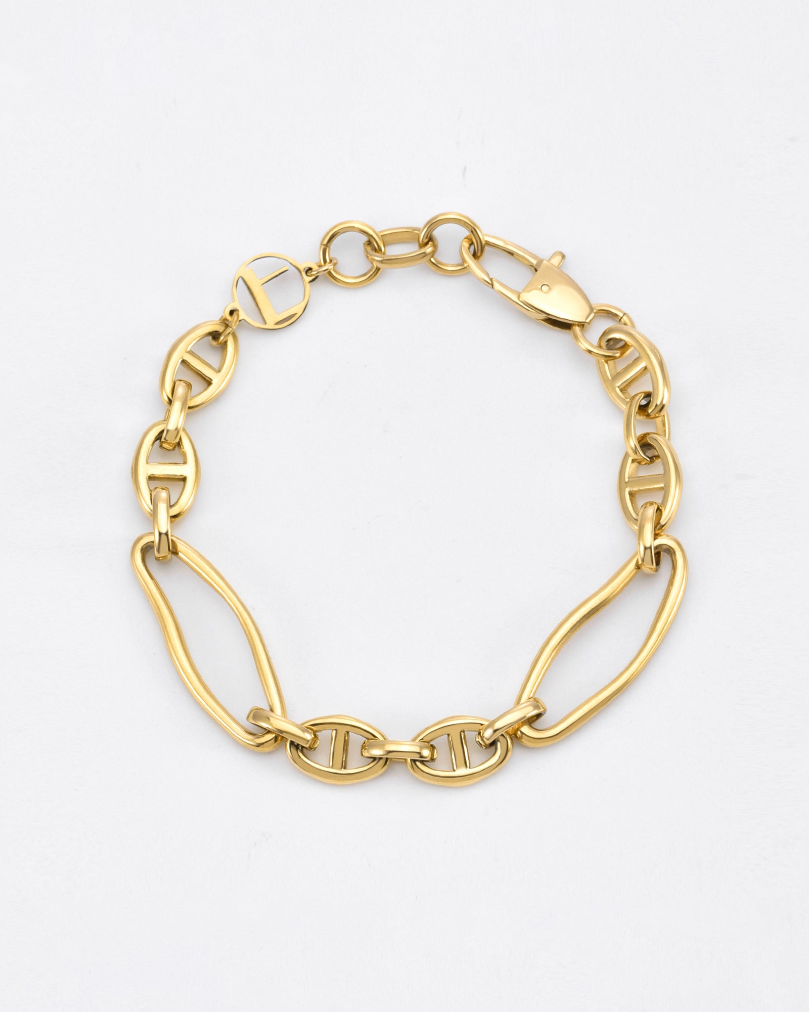 A delicate, 24k gold plated bracelet featuring an alternating pattern of oval and elongated link chains. It has a polished finish and a lobster clasp closure. This elegant Portrait Bracelet Gold by For Art's Sake® boasts a minimalist design against a plain white background and is hypoallergenic for sensitive skin.