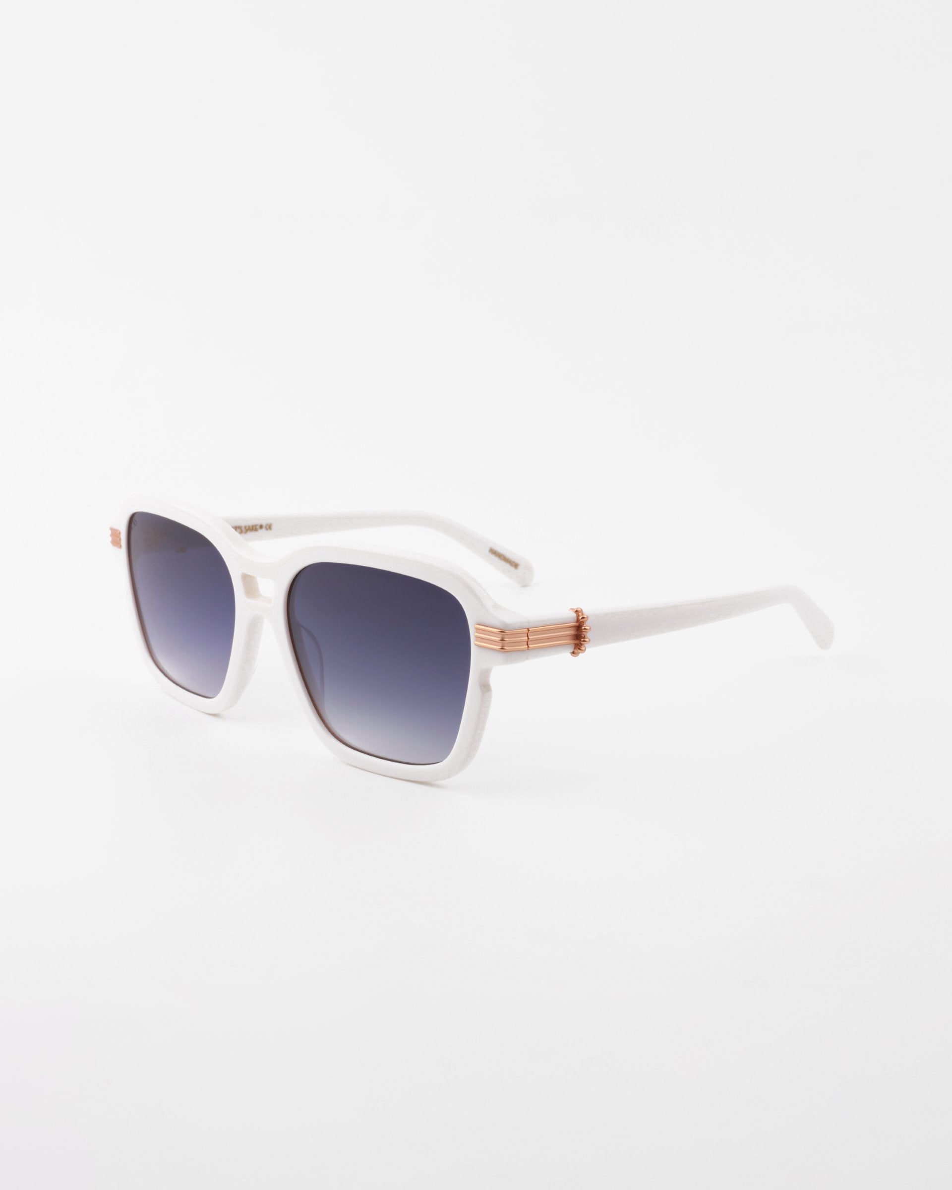 A pair of stylish white sunglasses with square frames, gradient dark to light shatter-resistant nylon lenses, and gold-plated temple detail on the hinges, displayed on a clean white background. The sunglasses are the Shadyside by For Art&#39;s Sake®.