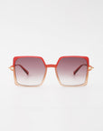 A pair of stylish handmade acetate For Art's Sake® Moxie sunglasses with large, gradient square lenses that transition from dark gray at the top to lighter shades towards the bottom. The frames are ombre, blending from red to a lighter tan hue with 18-karat gold-plated arms and offering full UVA & UVB protection.