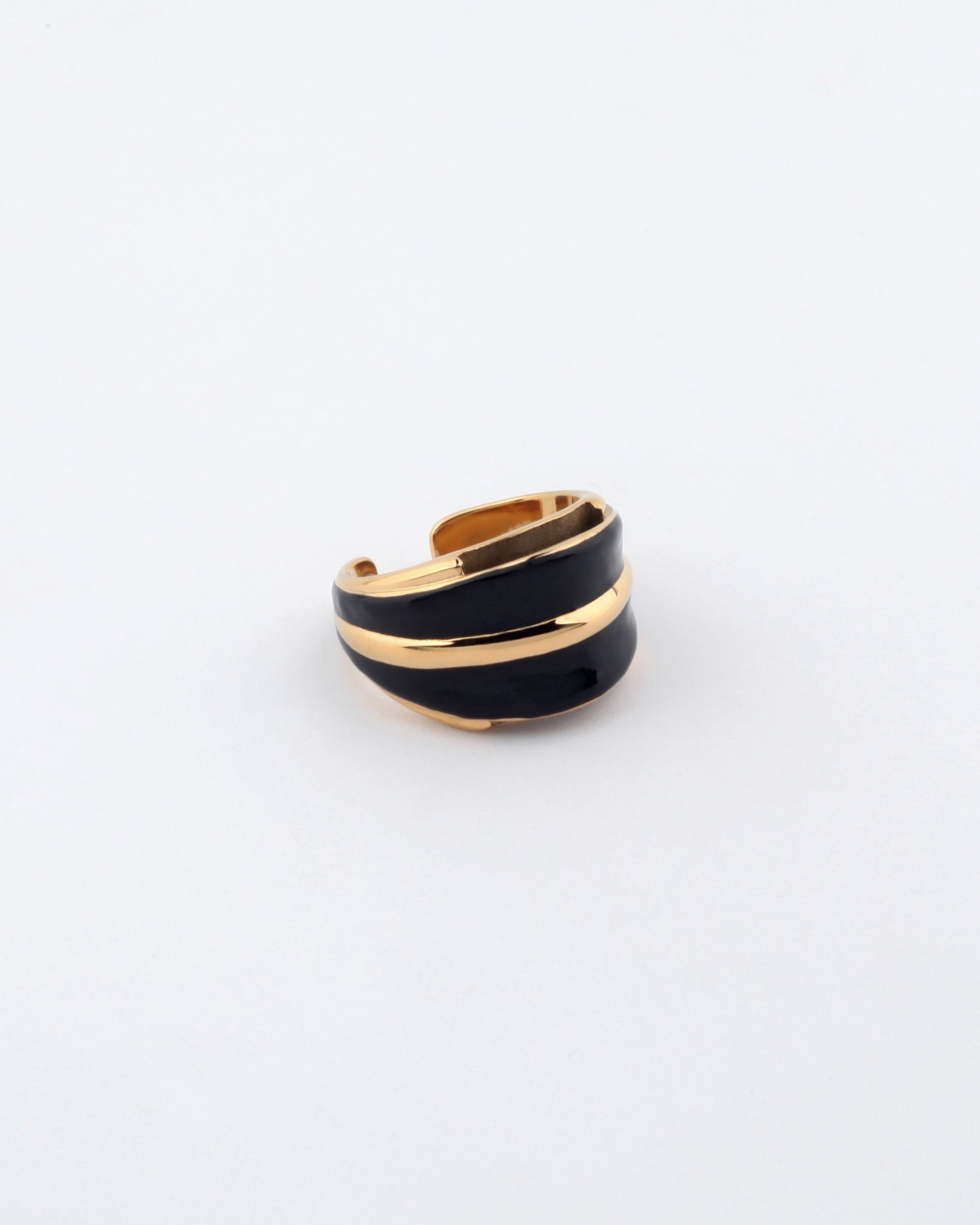 A stylish, open-ended Maven Ring by For Art&#39;s Sake®, featuring a sleek black band intertwined with shining gold-toned metal accents, displayed on a clean white background. The design is modern and elegant, making a bold statement.