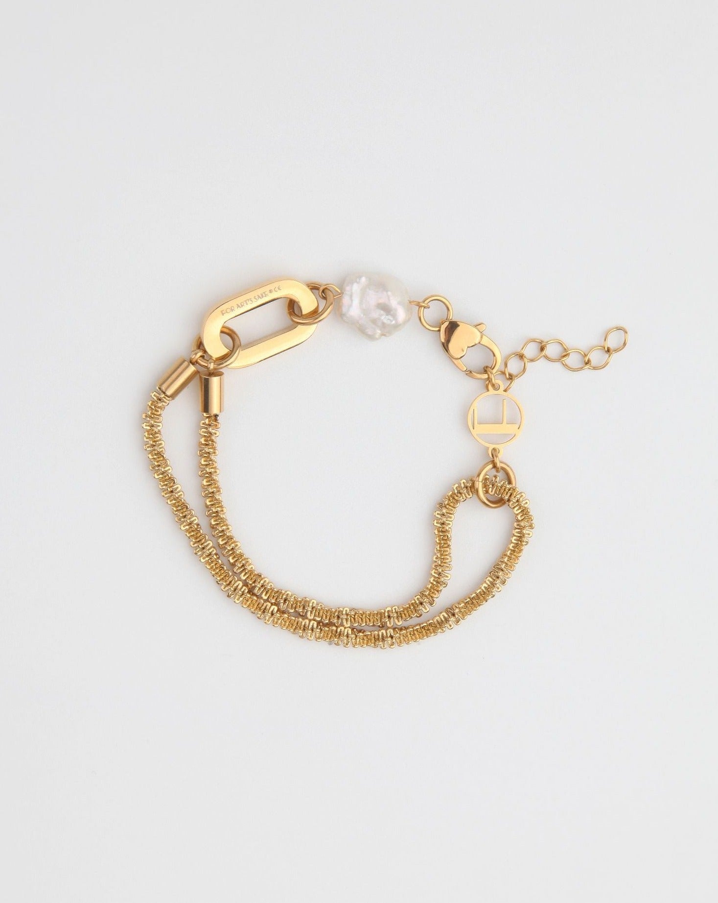 A delicate gold Raindrop Bracelet Gold by For Art&#39;s Sake® featuring an 18kt gold plating double chain design, a lobster clasp, and adjustable length with small circular links. It is adorned with a single irregular freshwater pearl and a unique rectangular link for added style. The bracelet is displayed on a light background.