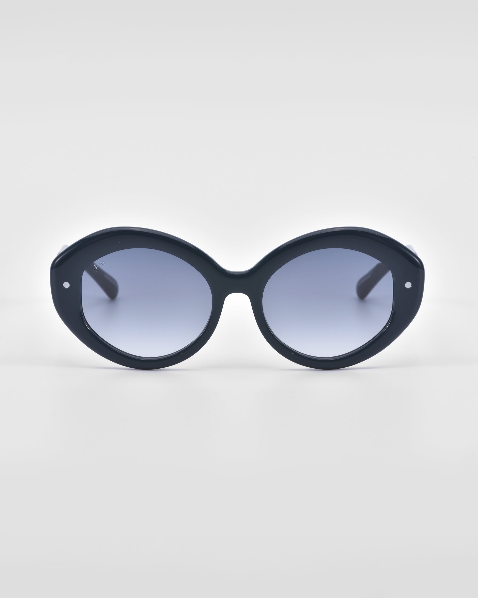 A pair of For Art's Sake® Helios sunglasses featuring an oversized, round design with tinted lenses is displayed against a plain white background, offering a touch of luxury eyewear.