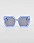 A pair of oversized, square For Art's Sake® Eos sunglasses with light blue frames and dark lenses against a white background.