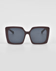 A pair of oversized soft-square For Art's Sake® Eos sunglasses with dark frames, viewed from the front against a plain white background. The lenses are tinted dark, providing a chic and fashionable appearance. Classic temple round details elevate the timeless charm, making these shades a stylish staple.