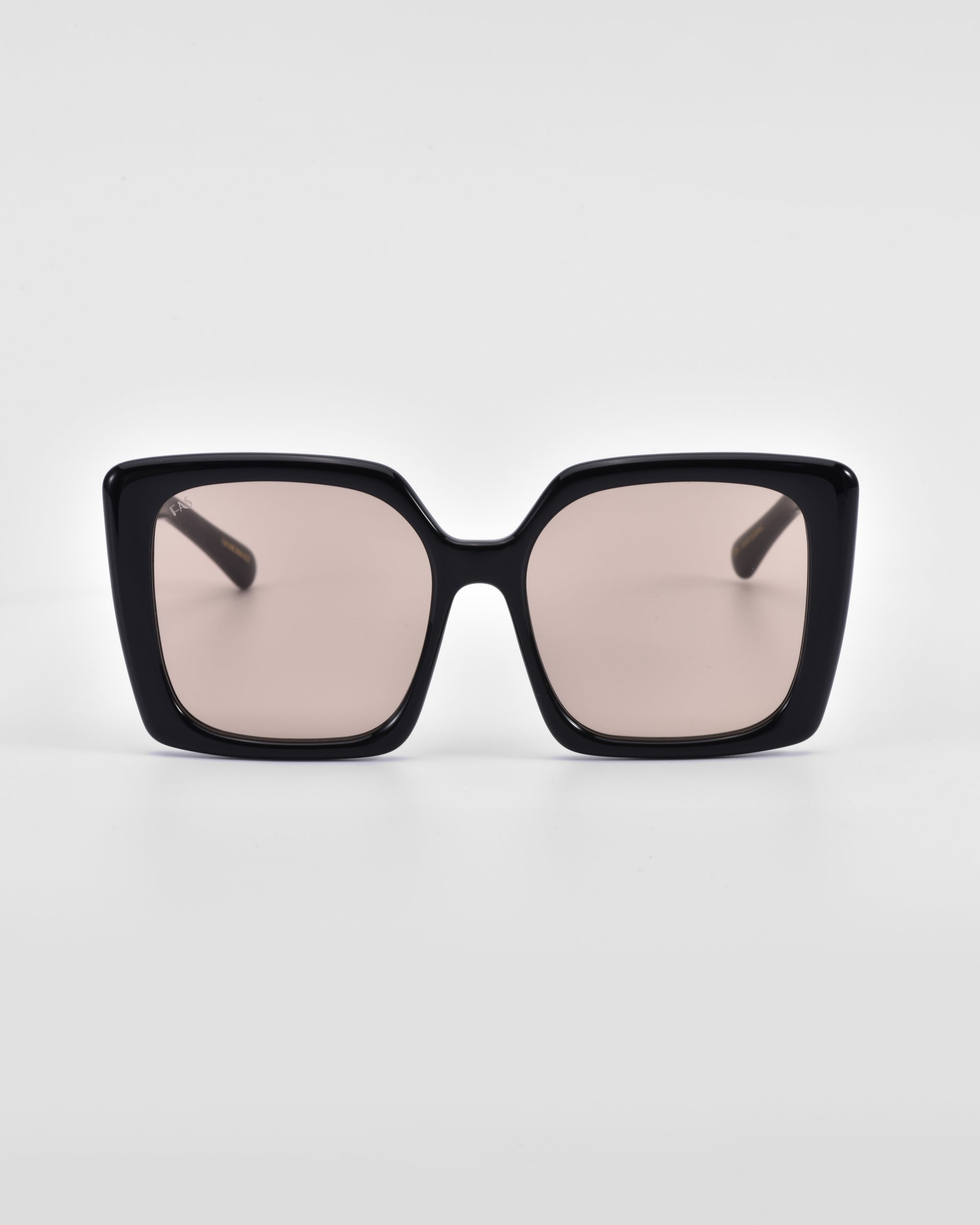 Front view of Eos oversized soft-square sunglasses by For Art&#39;s Sake® with black rims and pink-tinted lenses against a white background.