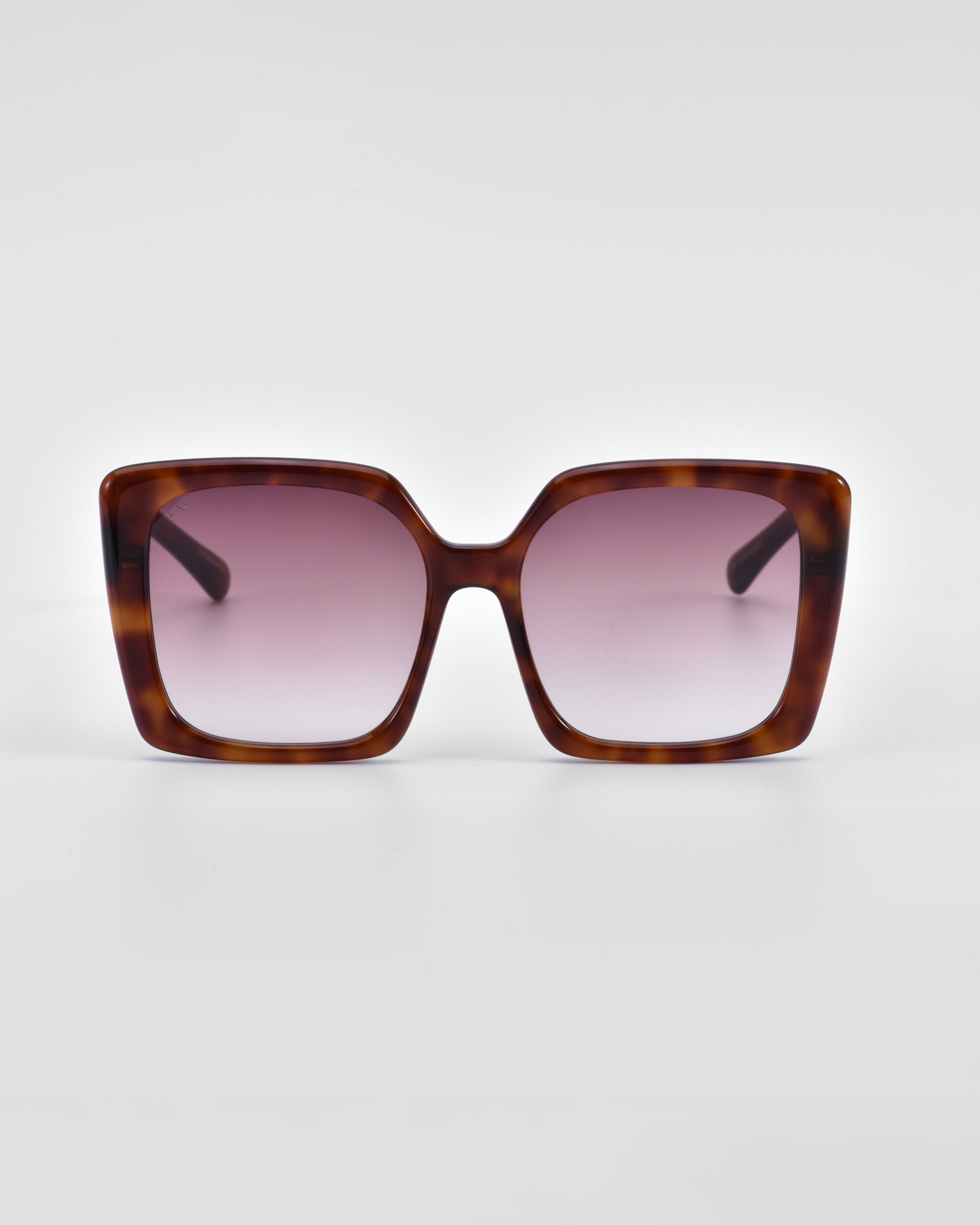 A pair of large, square-framed For Art's Sake® Eos sunglasses with a tortoiseshell pattern and gradient pink lenses is centered against a plain white background. Featuring an oversized soft-square silhouette, the For Art's Sake® Eos sunglasses have a modern, stylish design with wide arms.