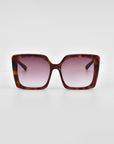 A pair of large, square-framed For Art's Sake® Eos sunglasses with a tortoiseshell pattern and gradient pink lenses is centered against a plain white background. Featuring an oversized soft-square silhouette, the For Art's Sake® Eos sunglasses have a modern, stylish design with wide arms.