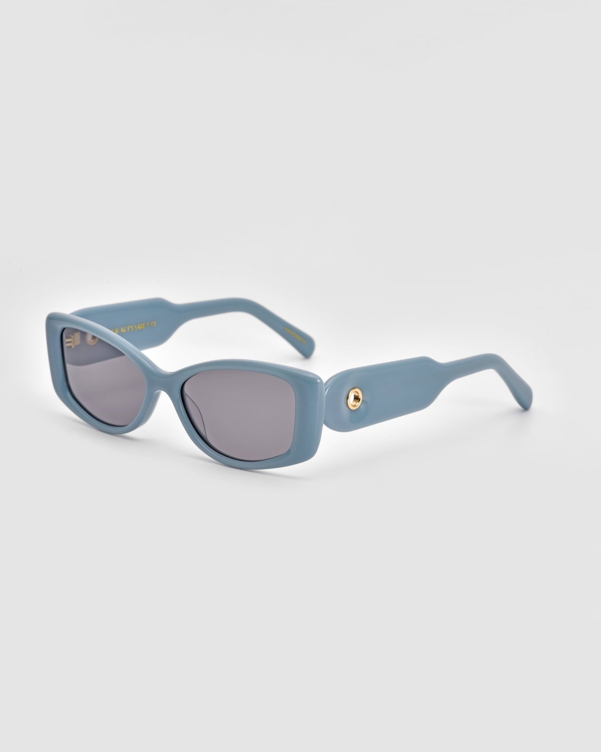 Experience luxury with the Mene sunglasses by For Art&#39;s Sake®, featuring light blue rectangular frames, dark lenses, and sleek arms, elegantly set against a plain white background.