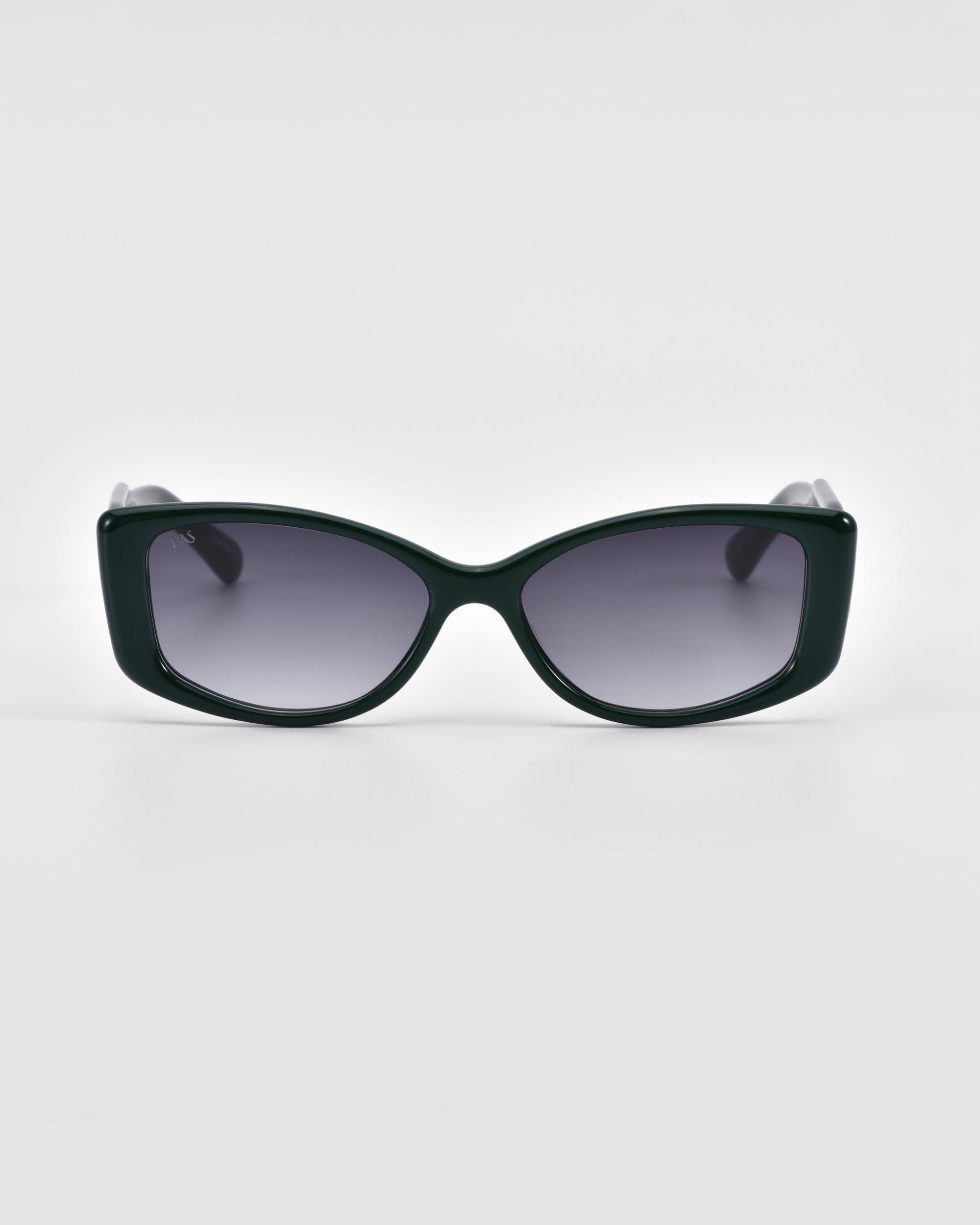 A pair of Mene by For Art&#39;s Sake® luxury frames in a cat-eye style with gradient grey lenses is centered against a white background.