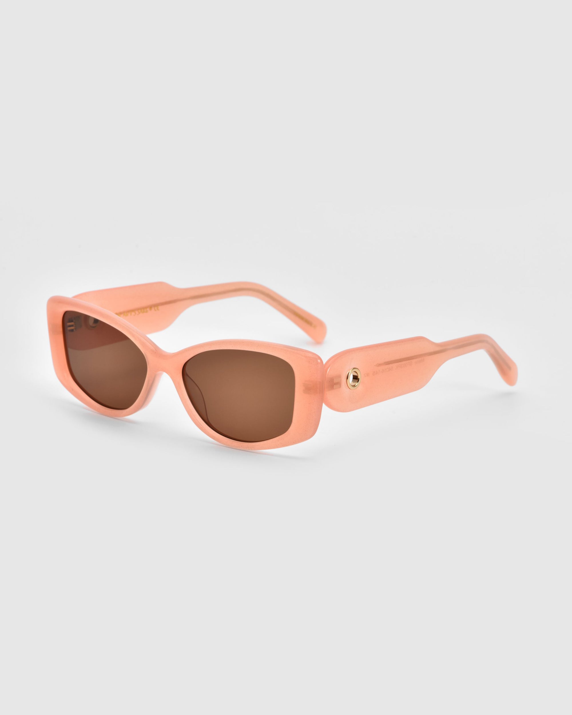 The Mene cat-eye sunglasses by For Art&#39;s Sake® showcase pink rectangular frames with brown lenses, exuding luxury, set against a plain gray background.