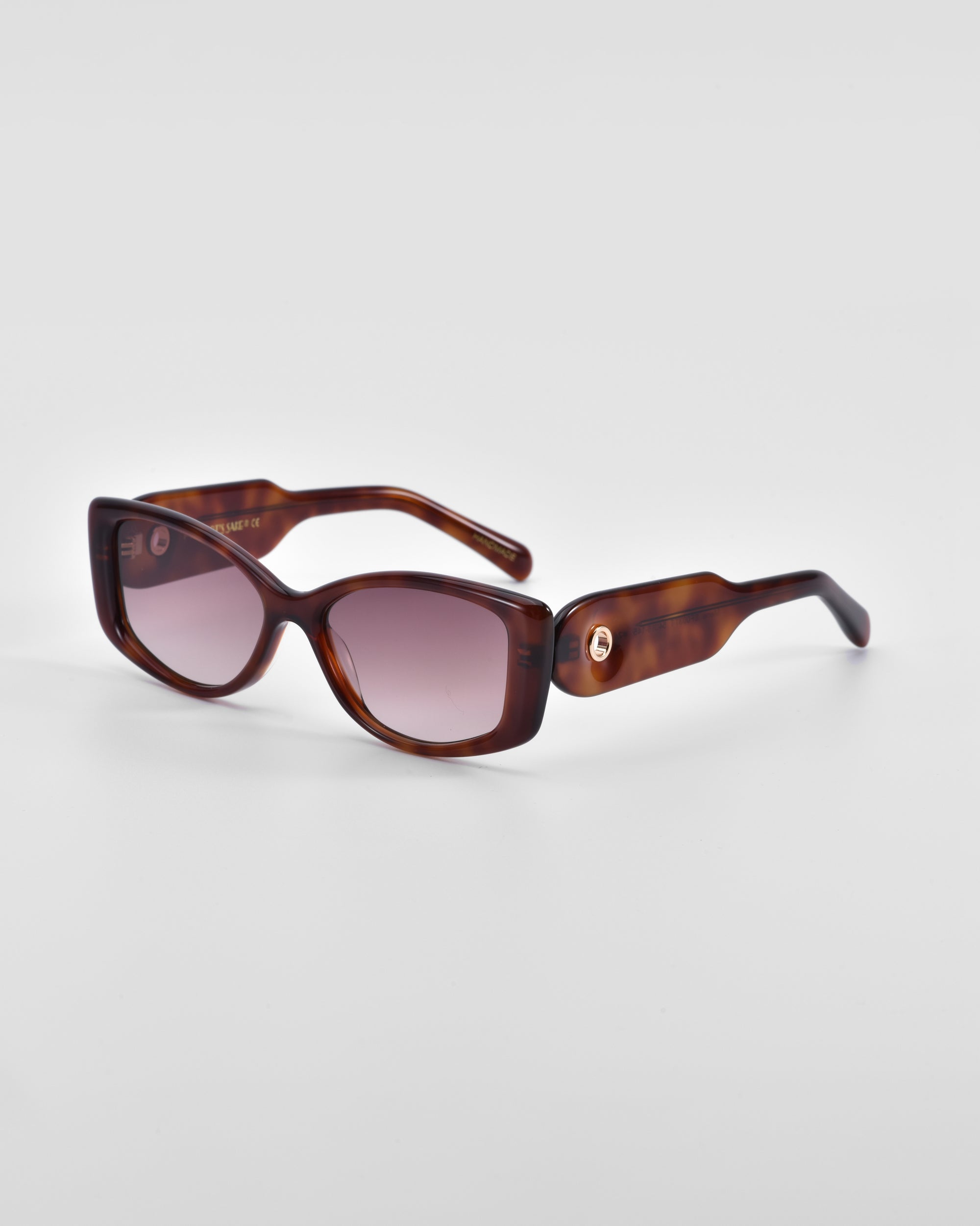 A pair of Mene by For Art&#39;s Sake® luxury tortoiseshell sunglasses with rectangular lenses tinted in a gradient from dark to light purple. The thick arms feature subtle 18 karat gold accents near the hinges, enhancing their refined elegance against a plain white background.