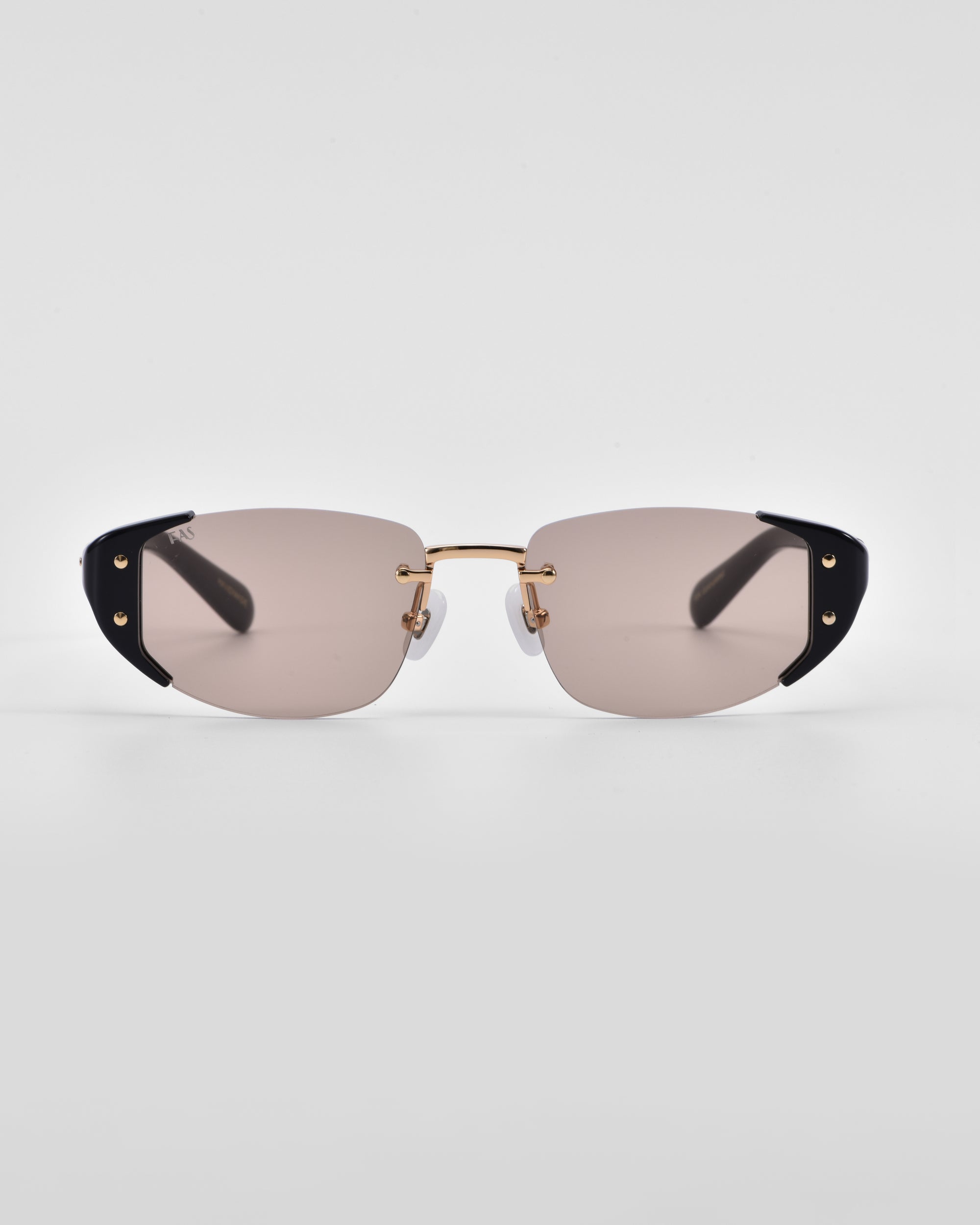 A pair of sleek For Art&#39;s Sake® Harbour sunglasses featuring rectangular, tinted lenses, gold metal frames, and black accents on the corners. The retro-inspired design is complemented by jade-stone nose pads, making them both minimalist and modern against a plain white background.