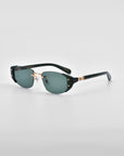 A pair of For Art's Sake® Harbour sunglasses featuring dark green lenses, black rims, and 18 karat gold plating on the hinges and nose bridge. These retro-inspired sunglasses are set against a plain light gray background.