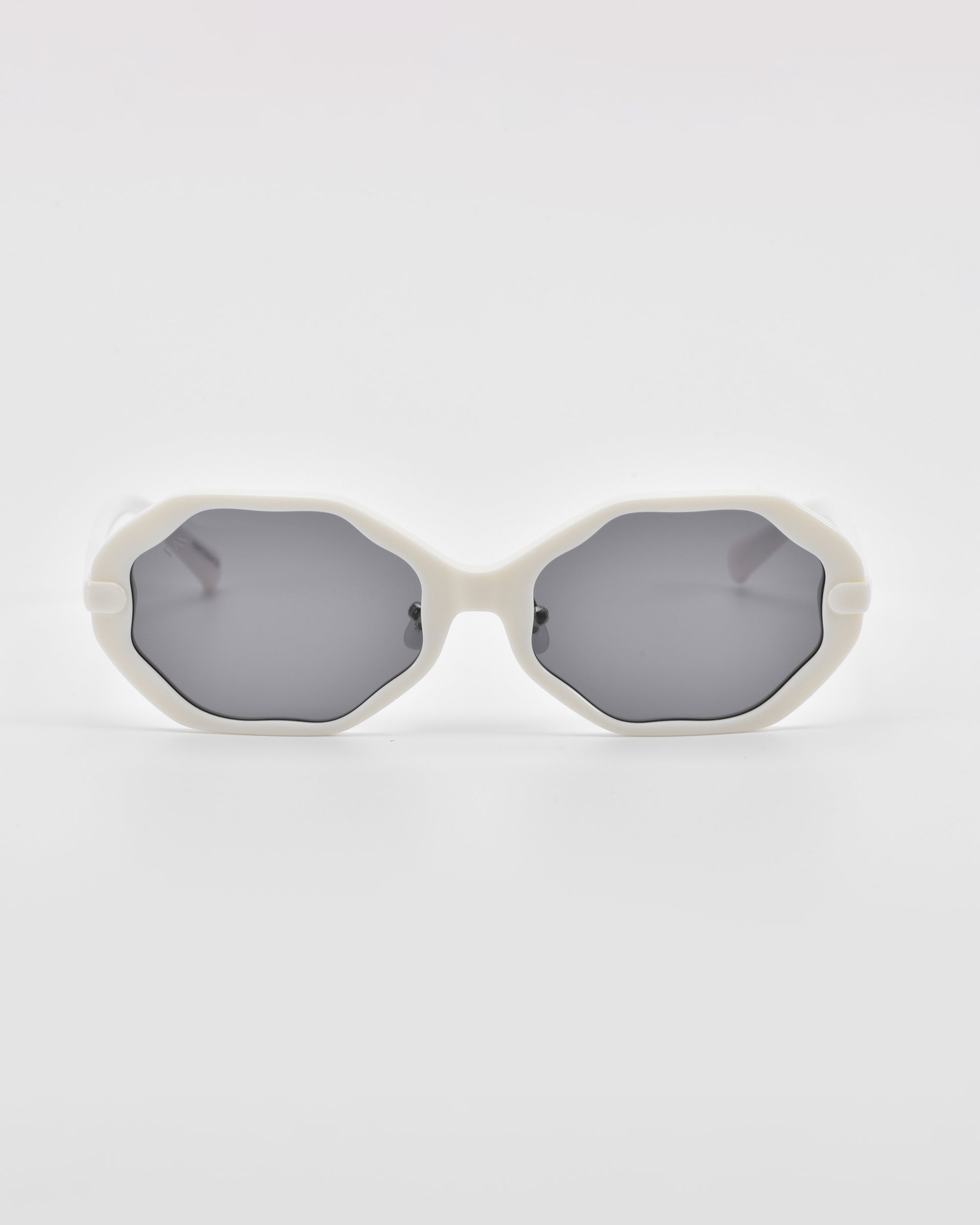 White, geometric-framed For Art's Sake® Lotus sunglasses with dark gray lenses, featuring an angular silhouette and shown against a plain white background.