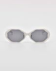 White, geometric-framed For Art's Sake® Lotus sunglasses with dark gray lenses, featuring an angular silhouette and shown against a plain white background.