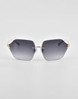 A pair of stylish For Art's Sake® Serpent II sunglasses featuring oversized, geometric hexagonal lenses with dark gray gradient tint and 18-karat gold-plated metal accents on the hinges and nose bridge, set against a plain white background.