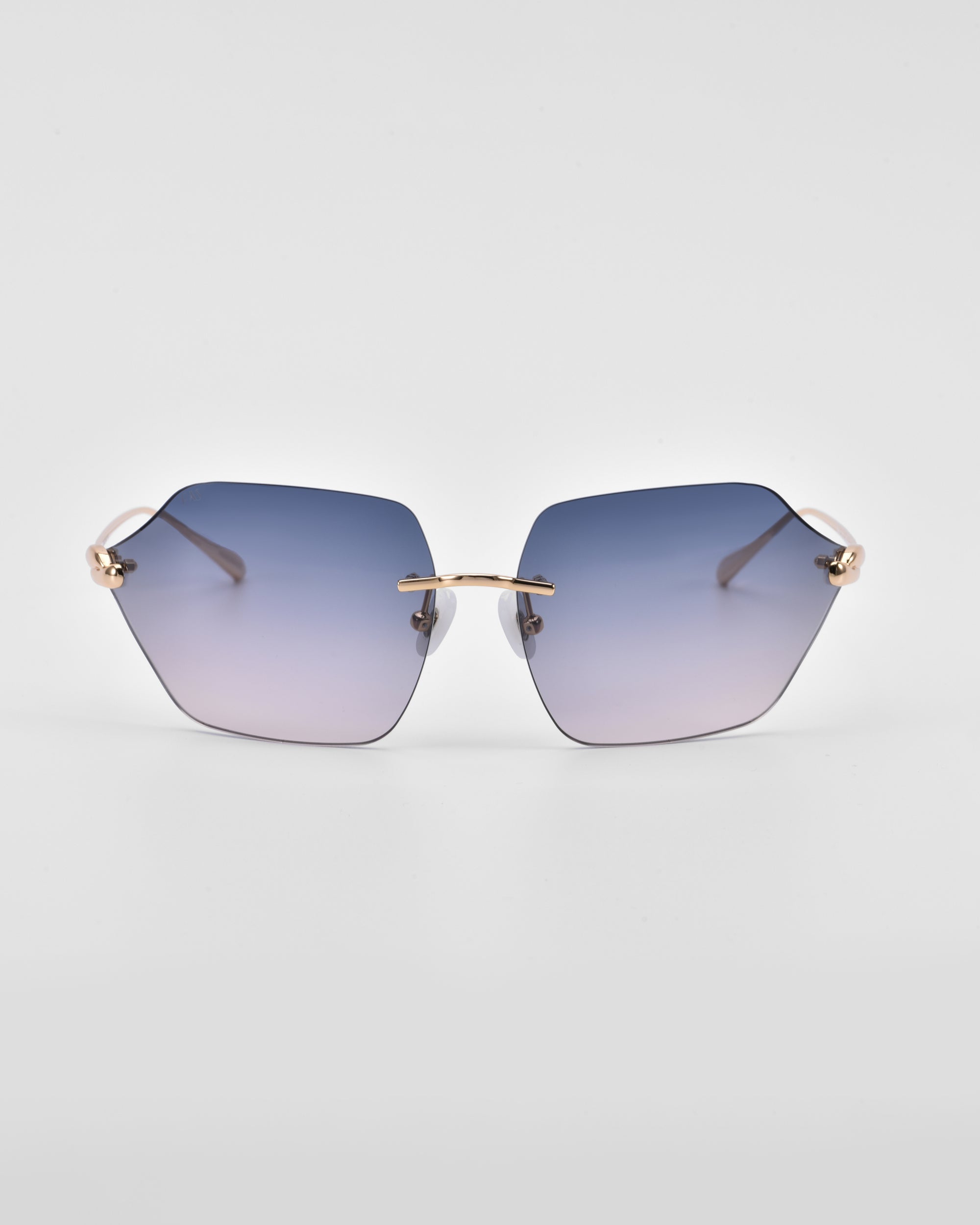 A pair of stylish For Art&#39;s Sake® Serpent II sunglasses with gradient purple lenses and gold detailing. The lenses have a unique pentagonal shape, enhanced by the 18-karat gold plating on the thin temples and nose bridge. The background is plain white.