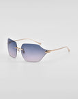 A pair of stylish For Art's Sake® Serpent II sunglasses featuring 18-karat gold plating on thin metal arms and a frameless wrap lens design with gradient lenses transitioning from a dark shade to a lighter blue at the bottom, set against a plain white background.