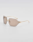 A pair of For Art's Sake® Serpent II sunglasses with rectangular, frameless wrap lens design and thin, 18-karat gold-plated arms. The brown-tinted lenses are showcased on a clean white background, highlighting their minimalist and modern aesthetic.