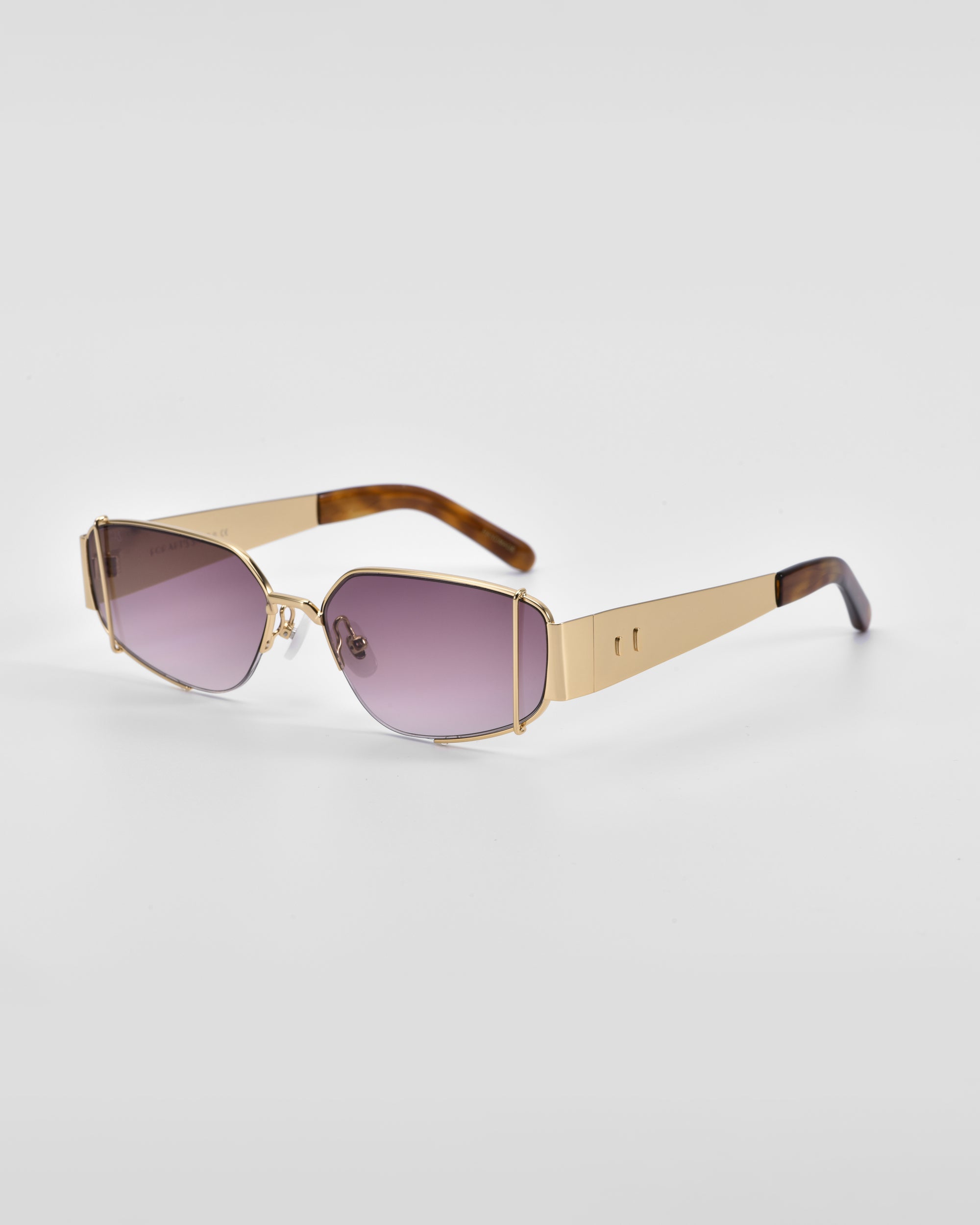 A pair of For Art&#39;s Sake® Talia designer sunglasses with 18-karat gold metallic frames and gradient purple-tinted lenses. The arms of the sunglasses are gold with tortoiseshell patterning near the ends. The sunglasses are set against a plain white background.