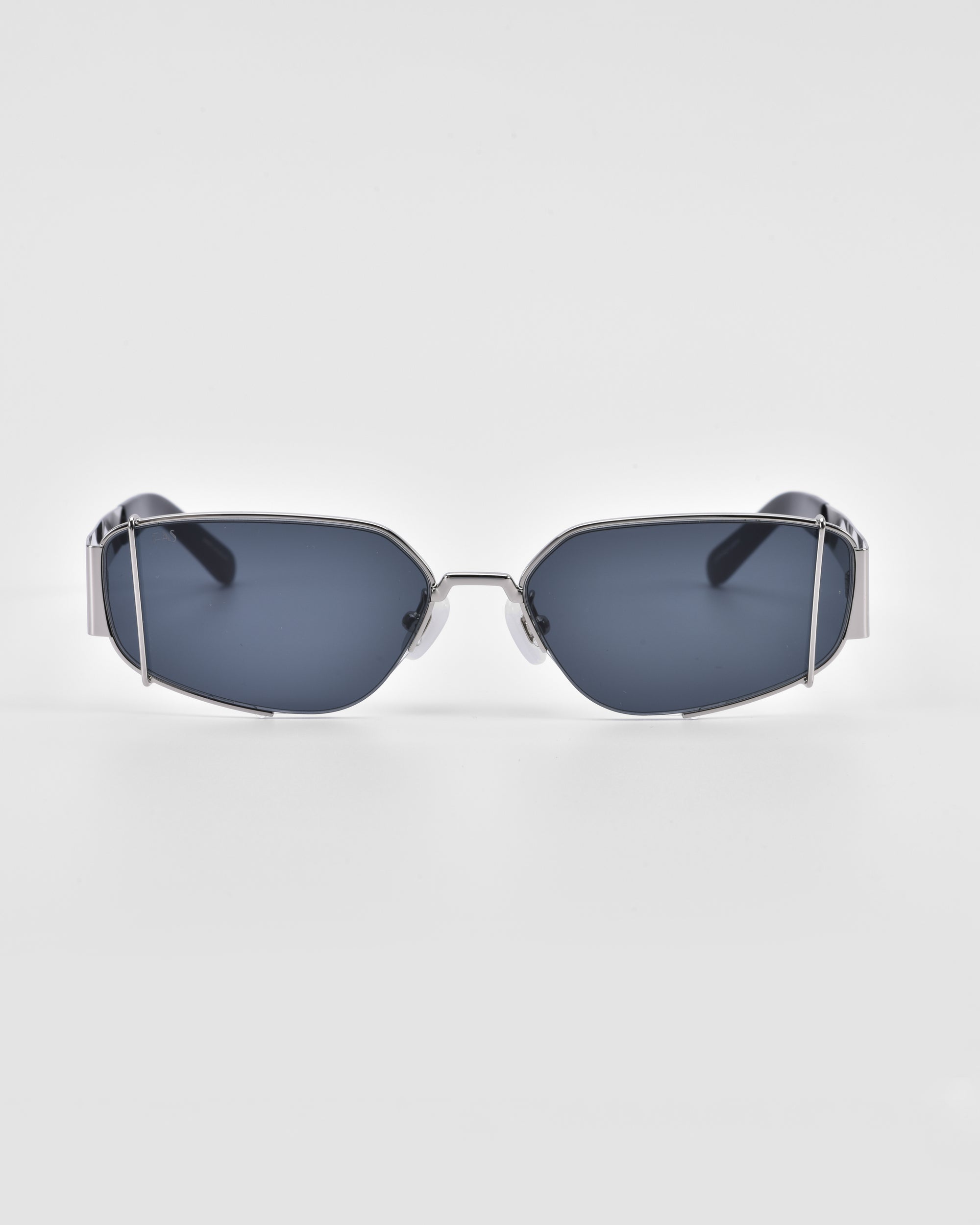 A pair of sleek, modern Talia sunglasses by For Art&#39;s Sake® with rectangular, dark-tinted lenses and thin 18-karat gold frames with an angular design, set against a plain white background.