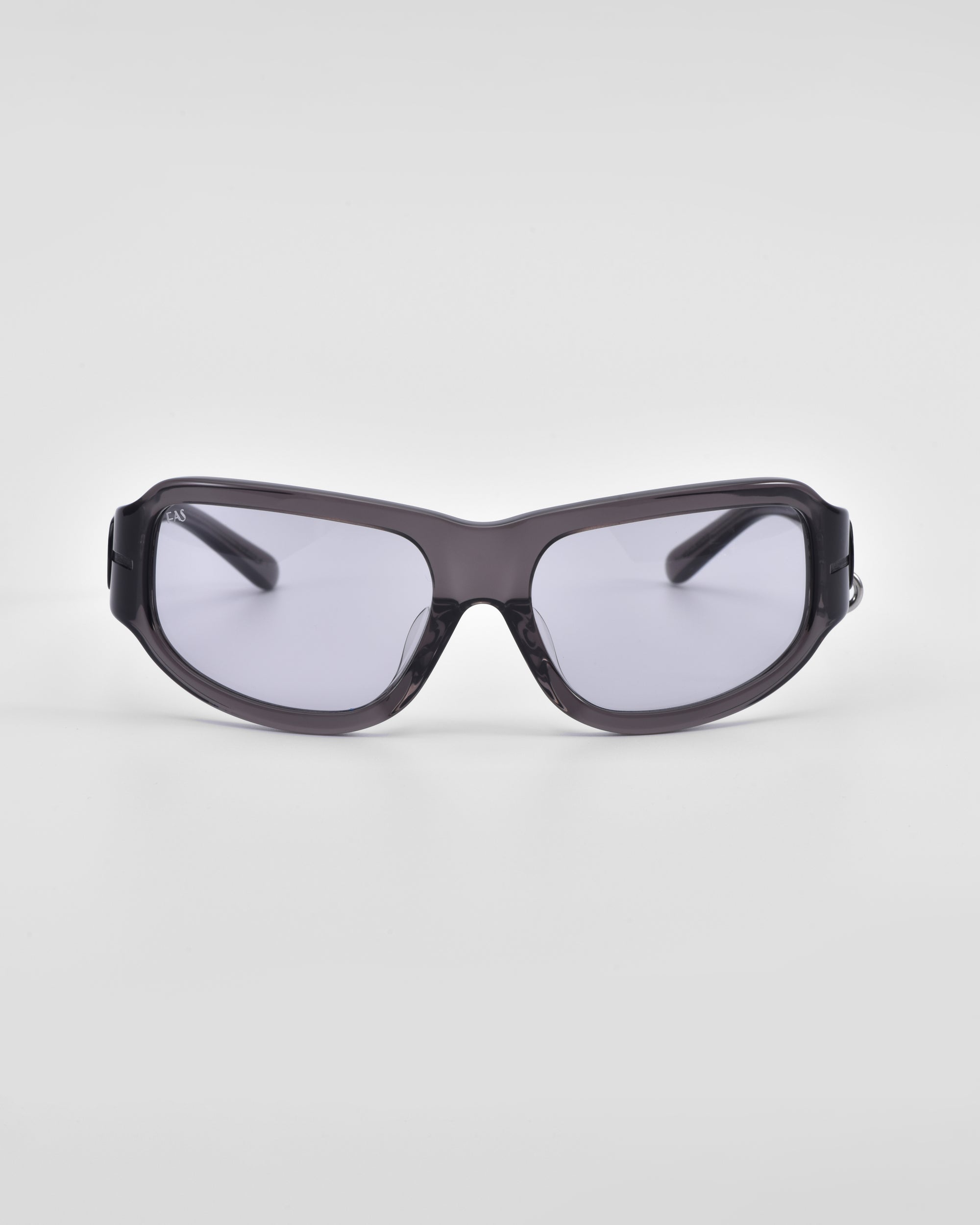 A pair of Raven sunglasses from For Art&#39;s Sake® in black, featuring slightly tinted lenses, is displayed against a plain white background. The Y2K wrap sunglasses boast a design with a curved frame and thick temples.