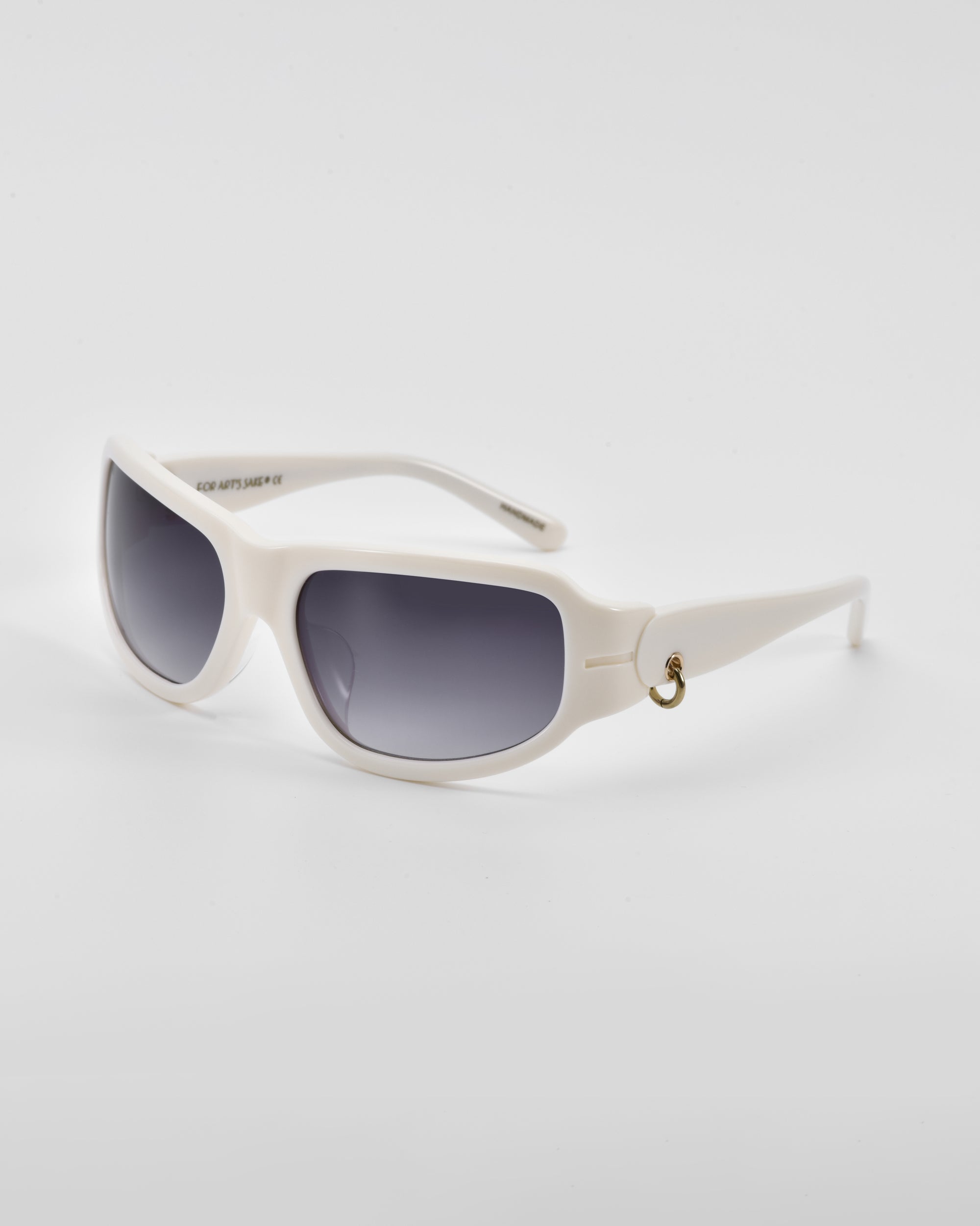 A pair of **Raven** wrap sunglasses with dark tinted lenses. The white frames have a sleek, modern design and feature a small 18-karat gold ring detail on the temples. The **For Art&#39;s Sake®** sunglasses are set against a plain white background.