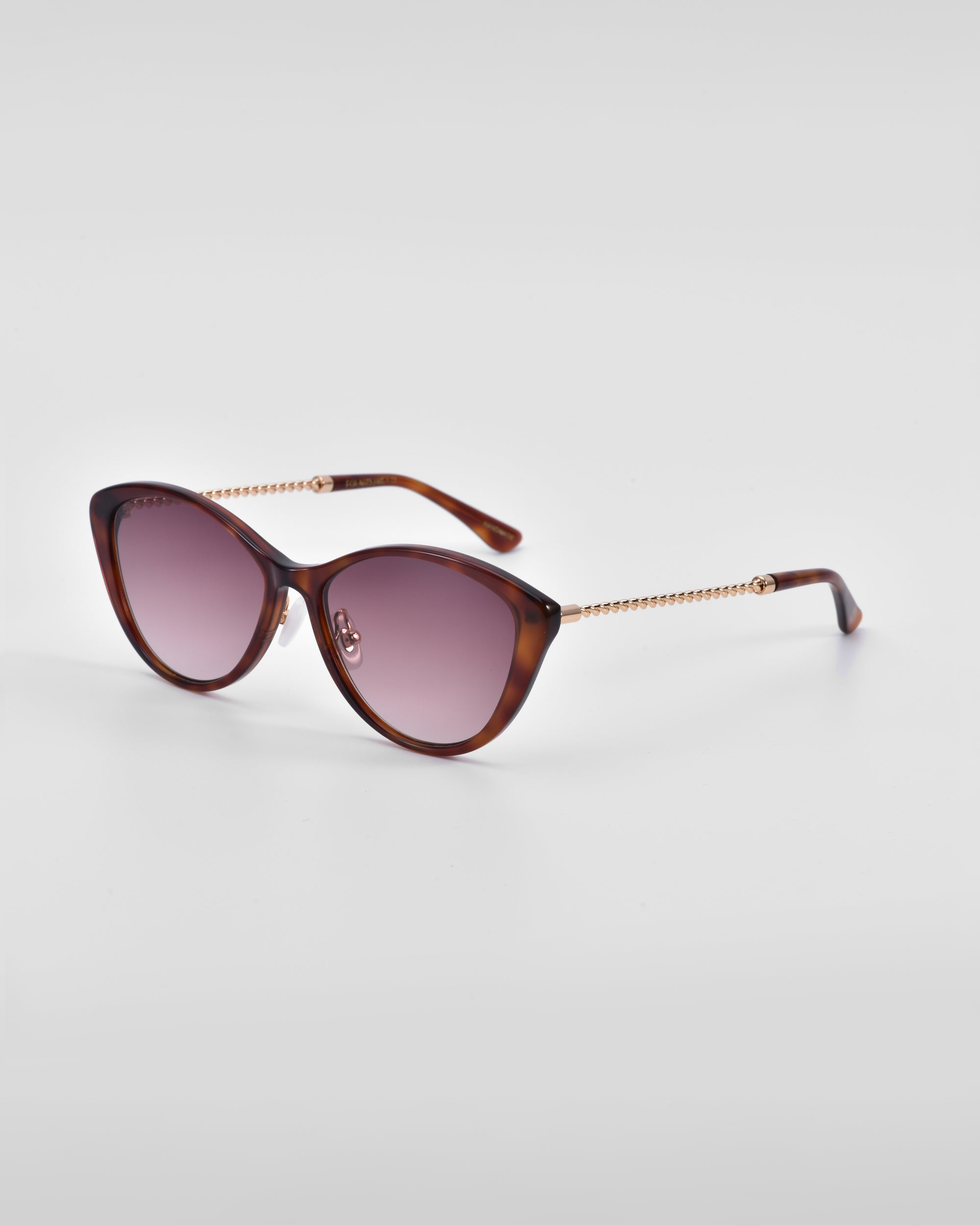 A pair of stylish sunglasses with dark earpieces and purple-tinted lenses. The frames are cat-eye shaped with a tortoiseshell pattern, and the arms feature a gold, chain-like design near the hinges. Jade-stone nose pads complete this elegant look against a plain white background. This is the Perla II by For Art&#39;s Sake®.