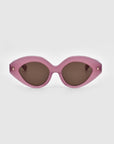 A pair of stylish, eco-friendly sunglasses called "Vera" by For Art's Sake® featuring a pink, cat-eye shaped frame and dark tinted lenses against a plain gray background. Small gold accents are visible on both sides of the frame near the hinges.