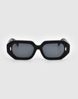 A pair of stylish, rectangular black sunglasses with thick frames and dark lenses. Crafted from biodegradable acetate by For Art's Sake®, the design features small, round metallic accents on the sides of the front frame. The plain white background makes these Vitamin D sunglasses stand out.