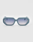 A chic pair of For Art's Sake® Vitamin D sunglasses featuring fashionable rectangular frames made of matte teal, biodegradable acetate. The gradient lenses transition smoothly from dark at the top to lighter at the bottom, and small oval accents on the temples near the lens frames add a stylish touch.