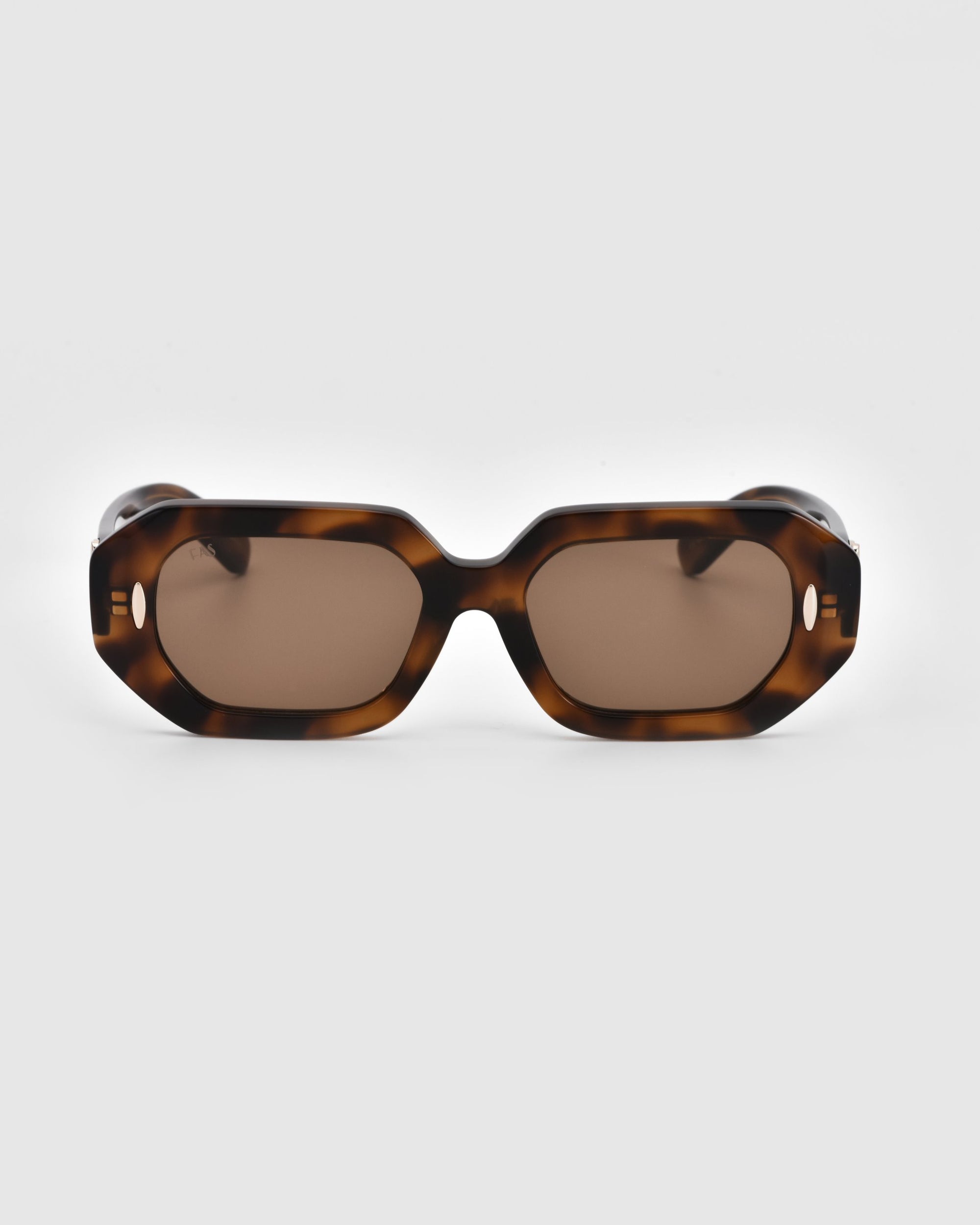 A pair of rectangular, tortoiseshell-patterned For Art&#39;s Sake® Vitamin D sunglasses with brown lenses set against a plain white background. The oversized frame, featuring a glossy finish and retro-inspired design, is crafted from stainless steel and biodegradable acetate.