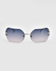 A pair of Hutton sunglasses by For Art's Sake®, featuring gradient blue-tinted rectangular lenses and thin metal arms. The frameless design adds a sleek, modern twist to vintage glamour, set against a clean, white background.