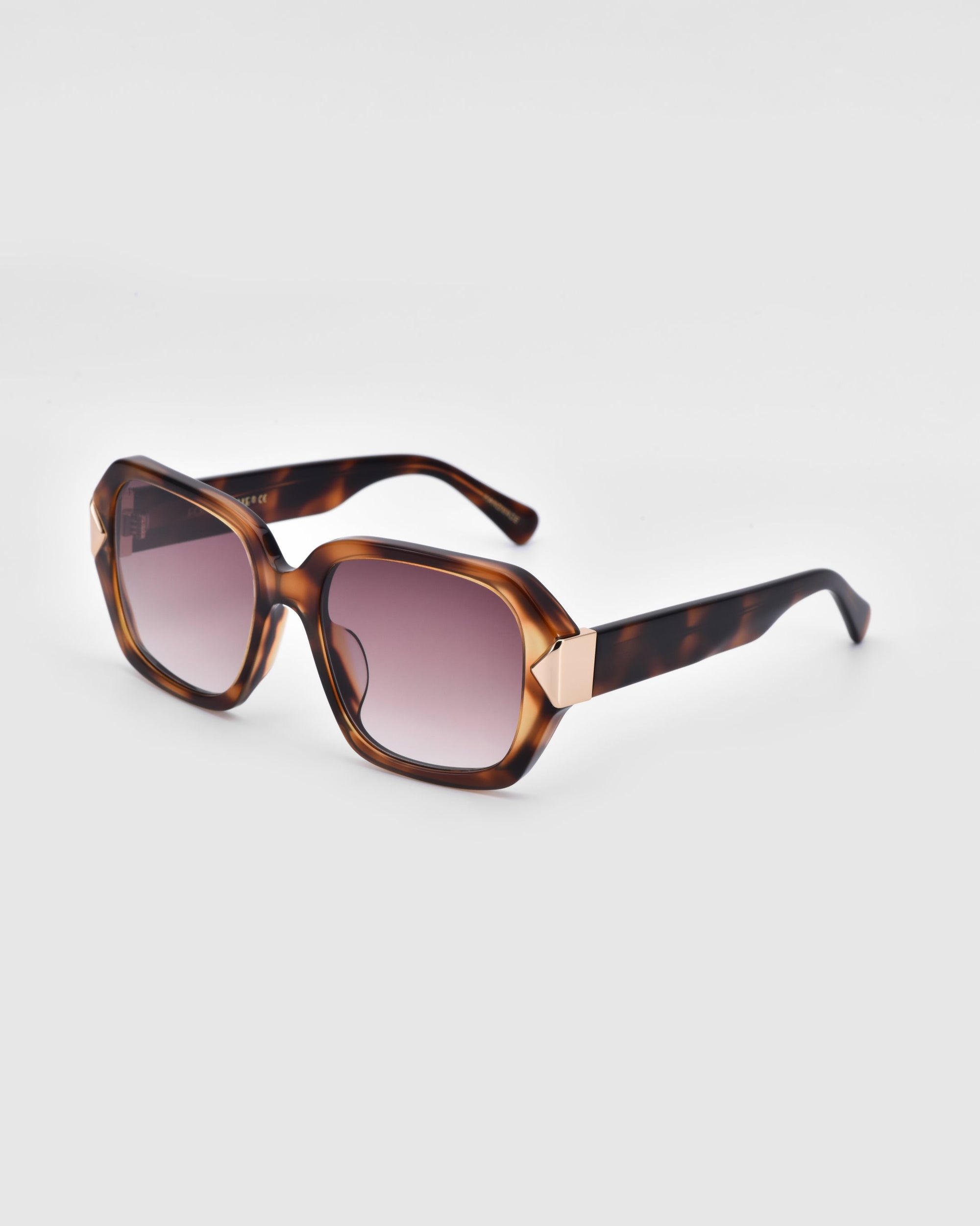 Introducing the Frankie sunglasses by For Art&#39;s Sake®: a pair of fashionable shades with large, square brown frames adorned with a chic tortoiseshell pattern and gradient lenses. Embodying modern boldness, the arms of these timeless design sunglasses feature elegant brown and gold accents near the hinges, all set against a plain white background.