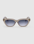 A pair of For Art's Sake® Bonbon sunglasses featuring a subtle blend of cat-eye silhouette and rectangular shape. They come with a light gray frame and dark tinted lenses, boasting a smooth, glossy finish with small gold accents near the hinges on each side, set against a plain white background.