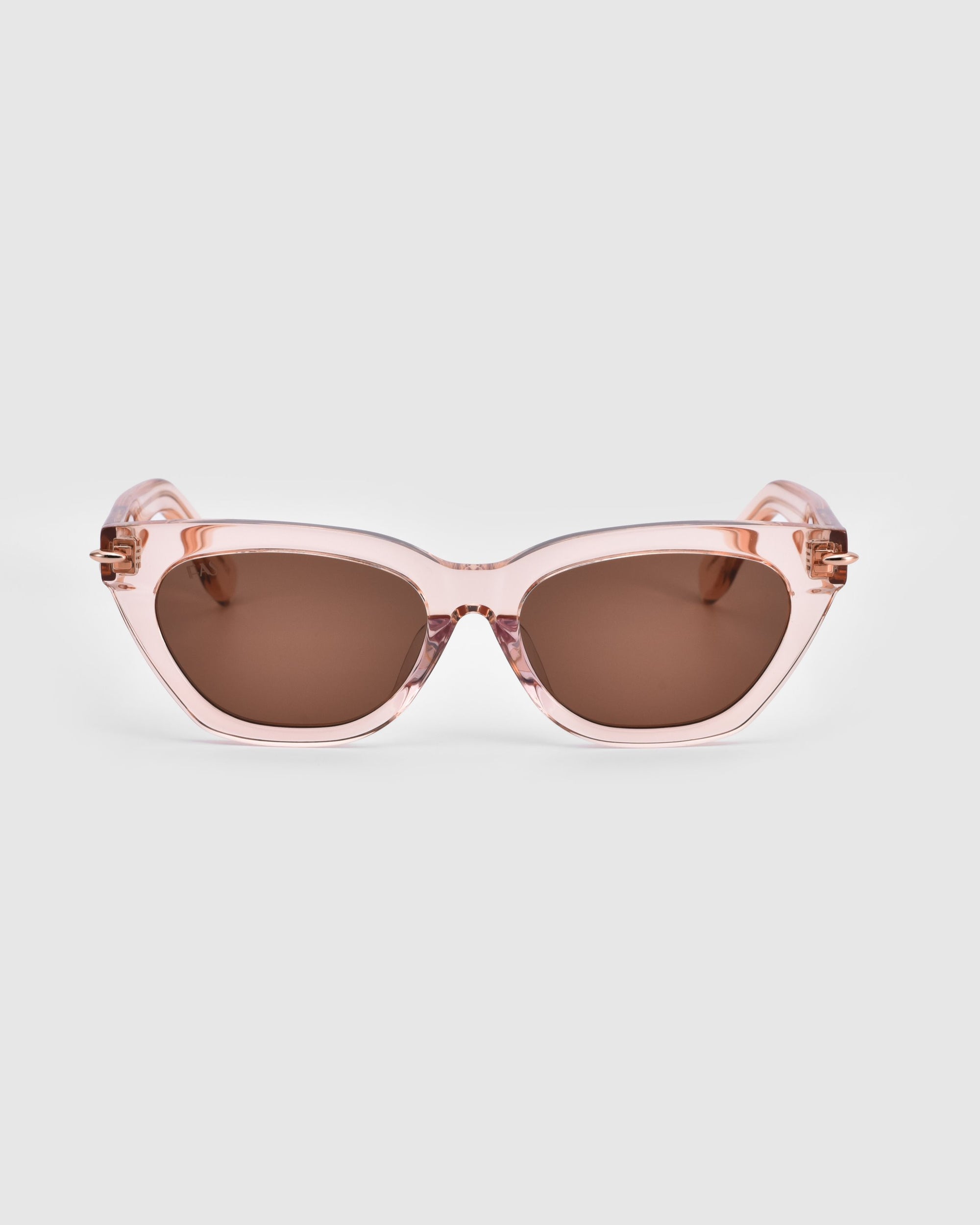 A pair of stylish pink Bonbon sunglasses by For Art&#39;s Sake®, featuring dark brown lenses, is shown against a plain white background. The thick frame has a shiny finish and showcases a subtle cat-eye silhouette.