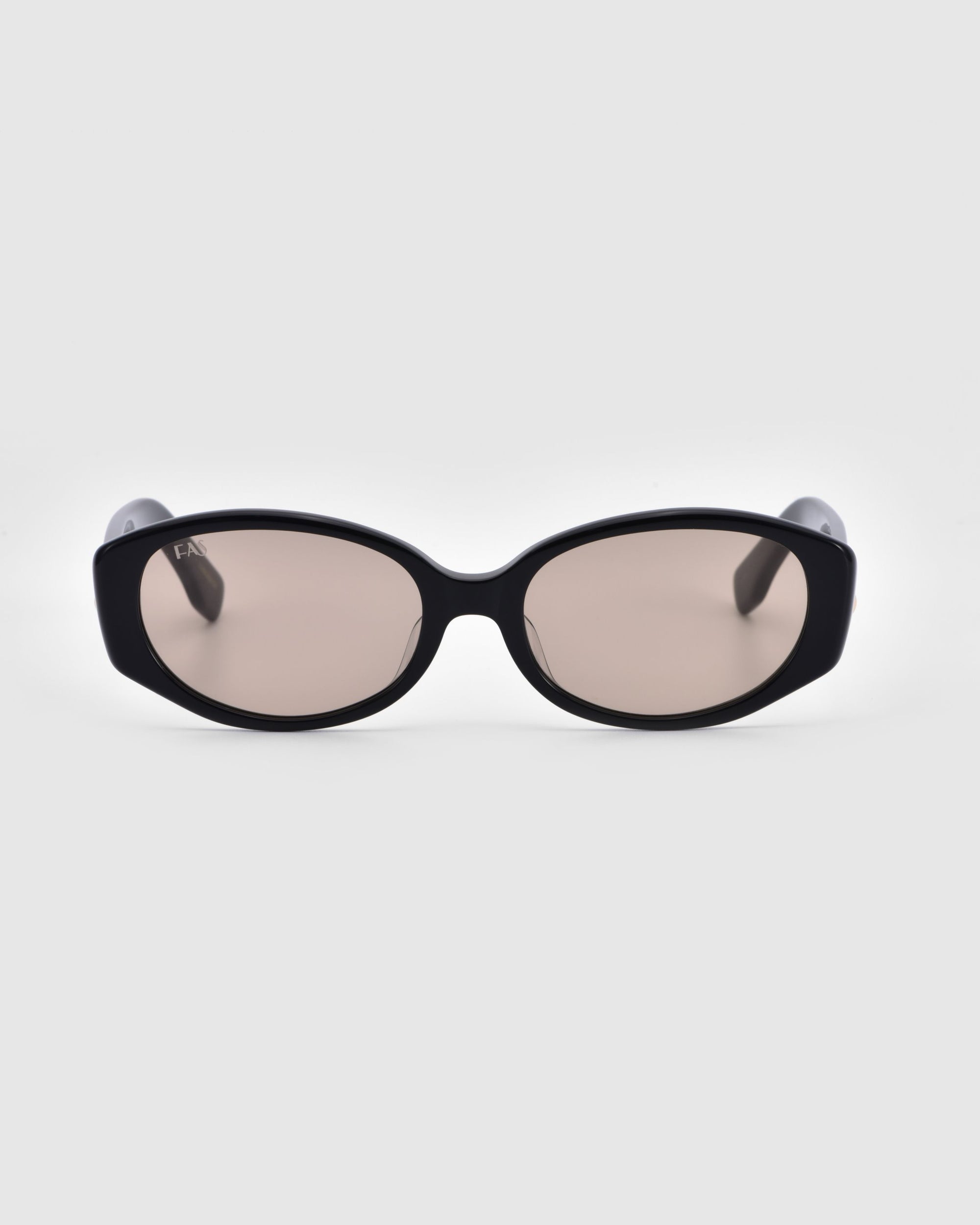 A pair of For Art&#39;s Sake® Friday sunglasses, featuring black oval-shaped frames with dark tinted lenses, is centered against a plain white background. The thick, glossy frames give a bold and modern look. Providing both style and UV protection, the slightly curved arms complete the sleek design.