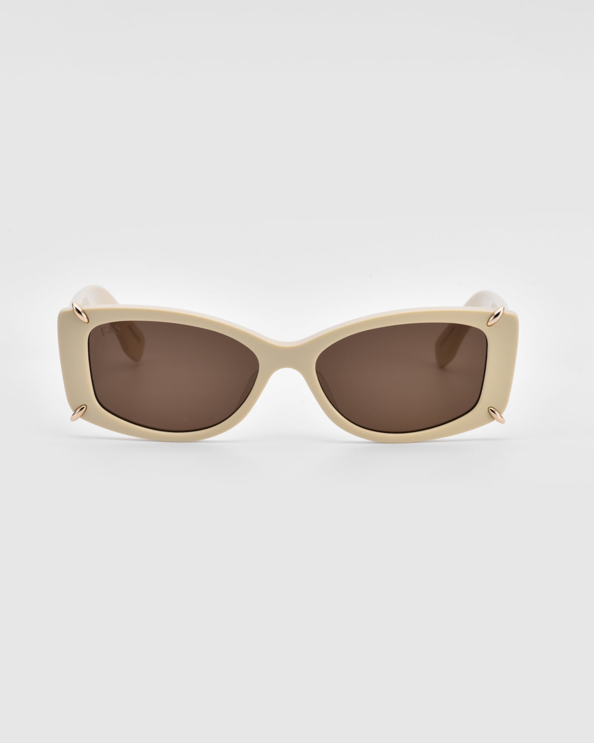 A pair of rectangular, off-white For Art's Sake® Dyer sunglasses with dark lenses. These sunglasses feature a sleek, modern design with small metallic accents at the corners of the frame, offering both luxury and UV protection. The photo is taken against a plain, light background.