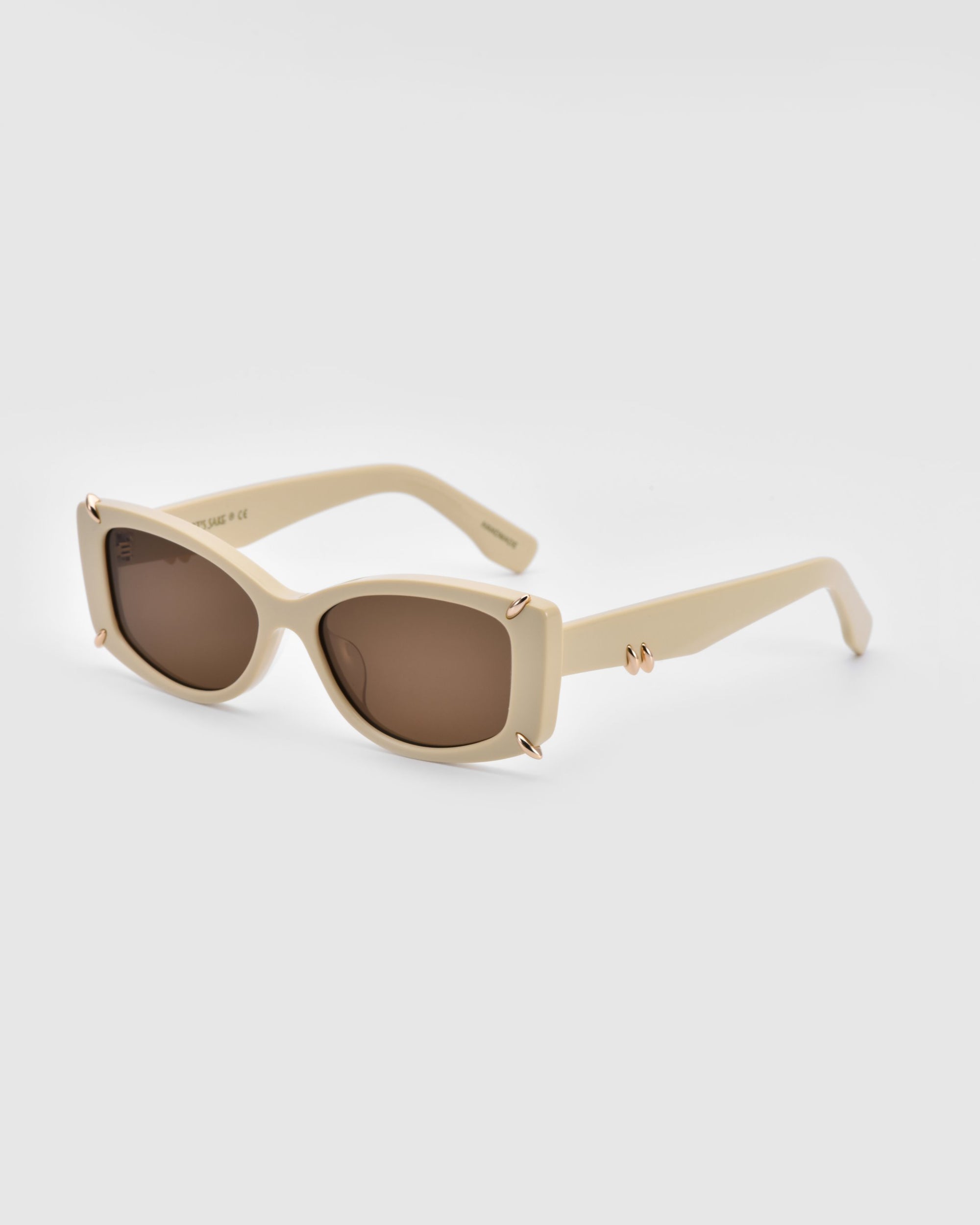 A pair of stylish, off-white rectangular Dyer sunglasses from For Art&#39;s Sake®, featuring brown-tinted lenses and subtle gold accents on the hinges. These sunglasses boast a chic, modern design suitable for trendy fashion wear while offering excellent UV protection.