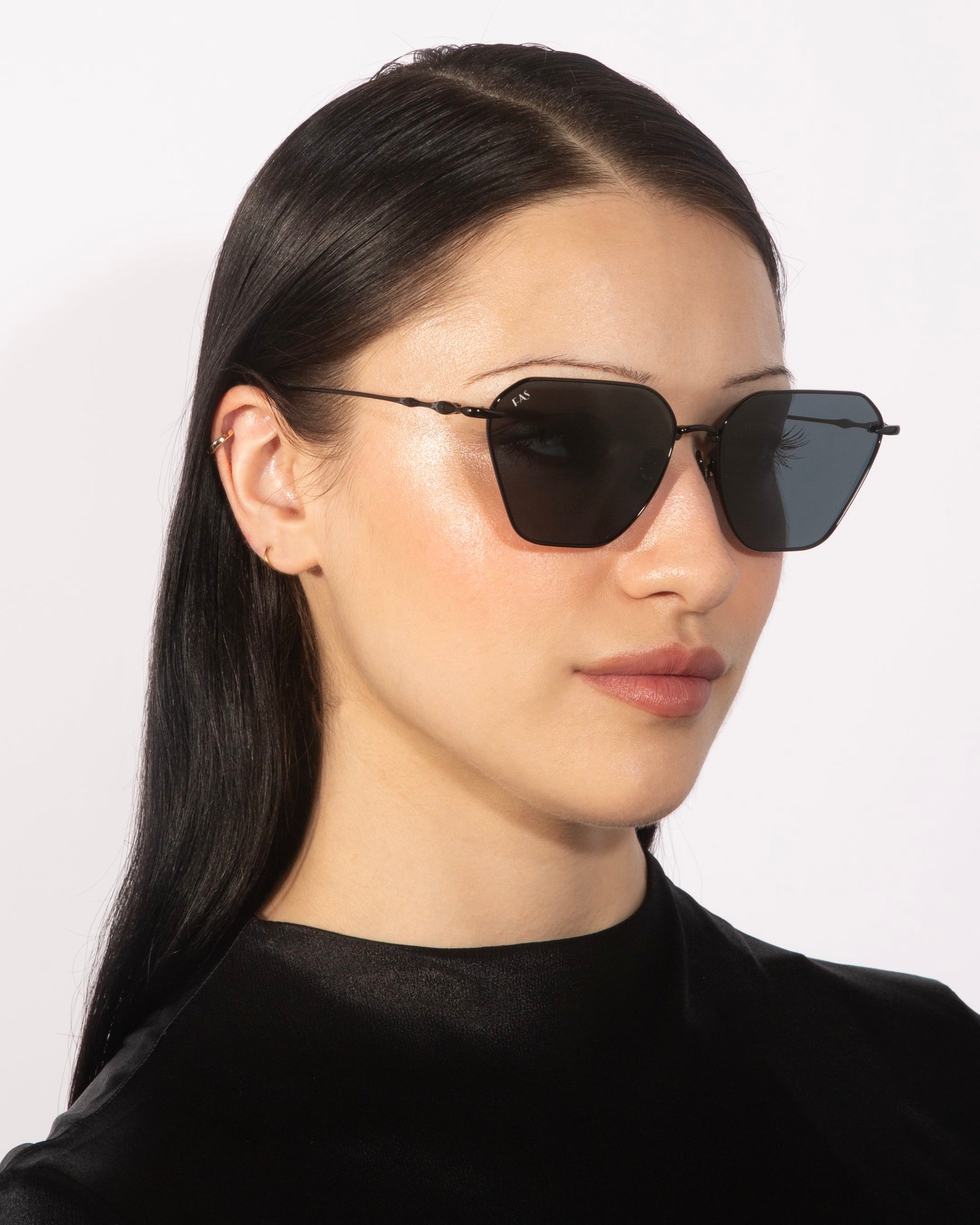 A person with long, straight black hair is wearing large, rectangular Cece sunglasses from For Art&#39;s Sake® with gradient lenses and a black top. They are facing slightly to the right, against a plain white background.