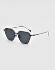 A pair of For Art's Sake® Cece sunglasses featuring thin, black metal frames and dark, rectangular lenses, showcased on a plain, light grey background. These stylish sunglasses come equipped with comfortable nose pads and slightly curved earpieces.