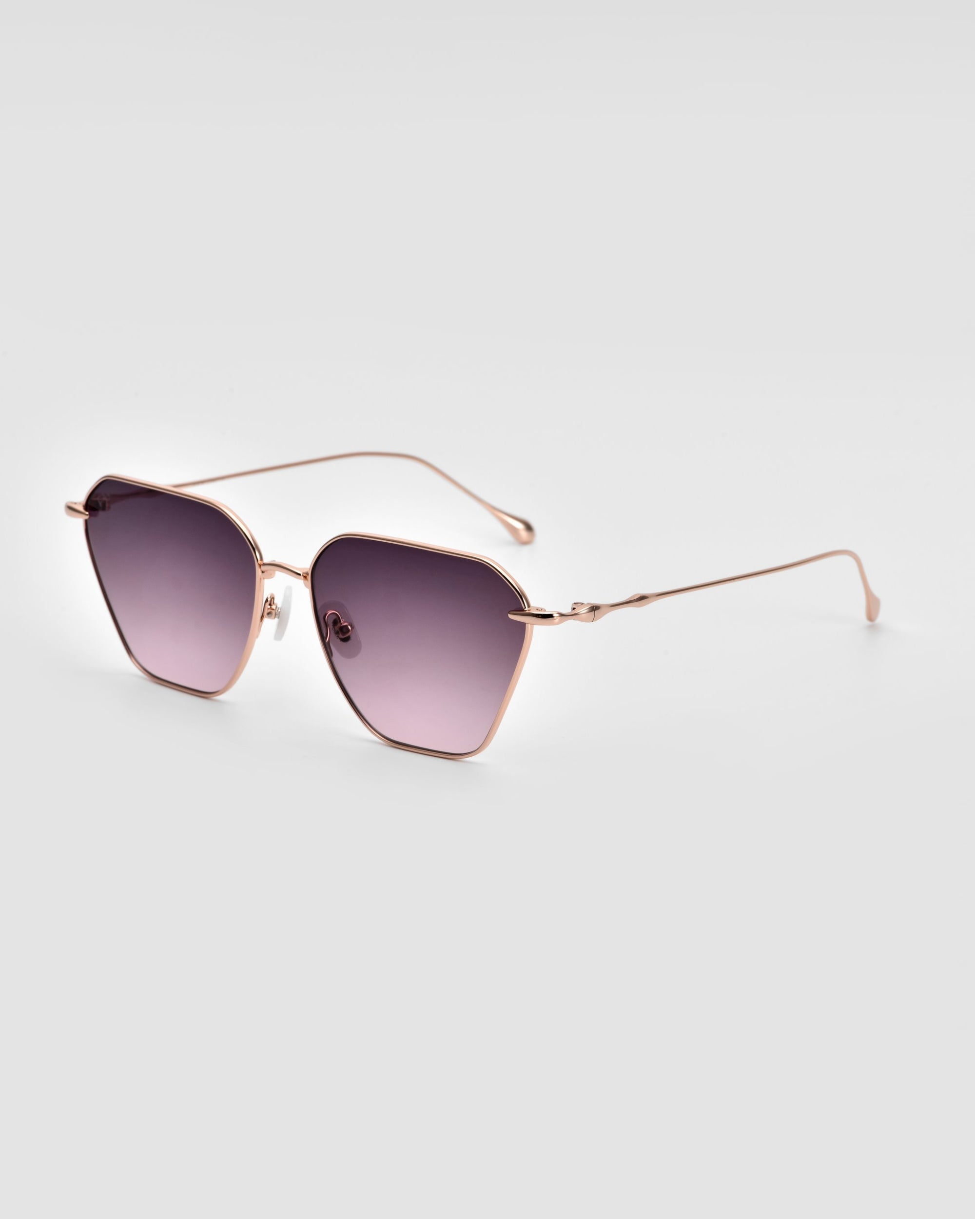 The For Art&#39;s Sake® Cece Sunglasses, showcasing rose gold frames and dark gradient lenses, are displayed on a white background. The frames feature a subtle geometric shape with thin temples, a delicate nose bridge, and adjustable nose pads.